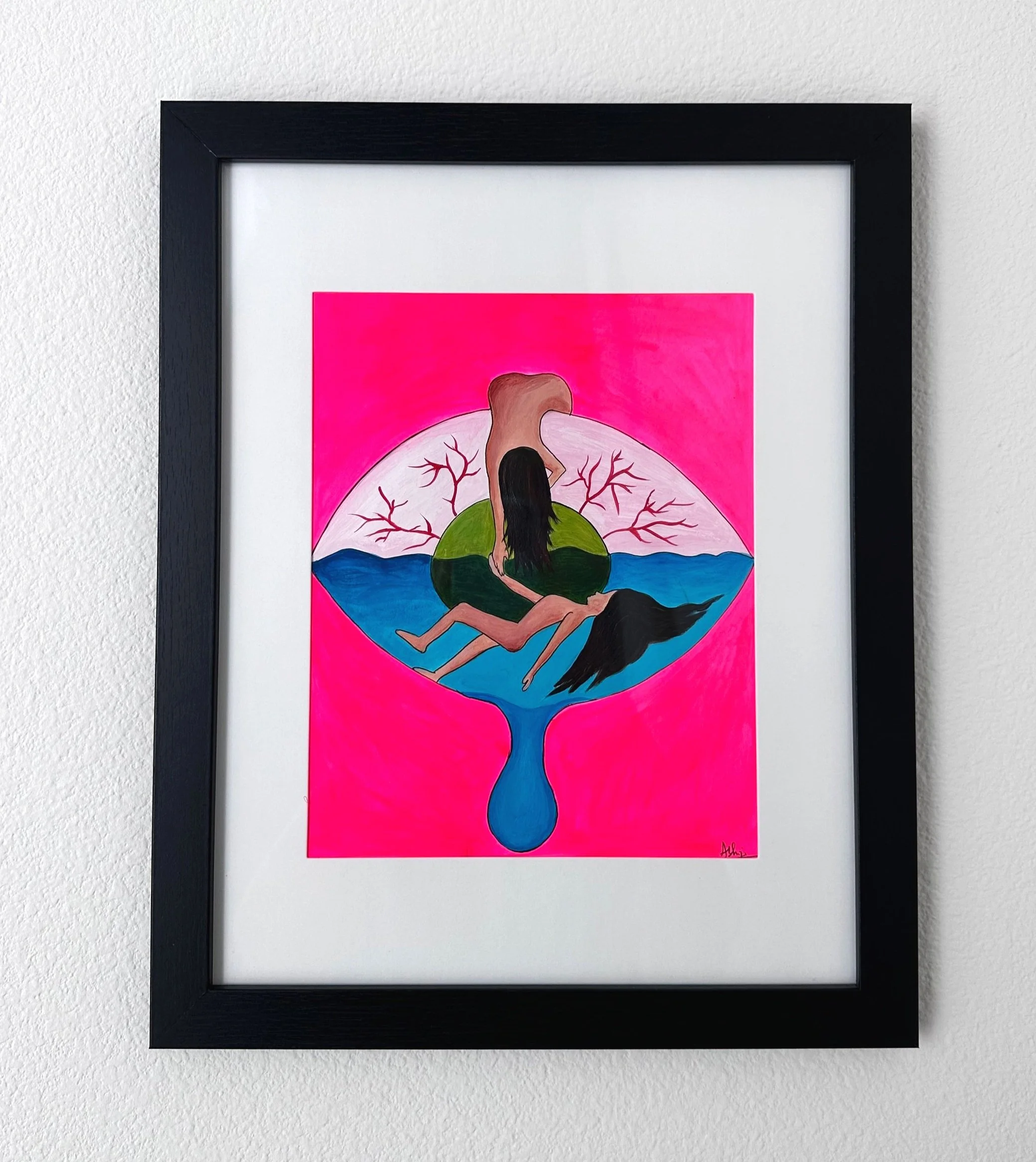 A framed colorful painting of two women, one with long black hair, sitting on a green island inside a blue and white teardrop-shaped vessel, with a pink background featuring leafless trees.
