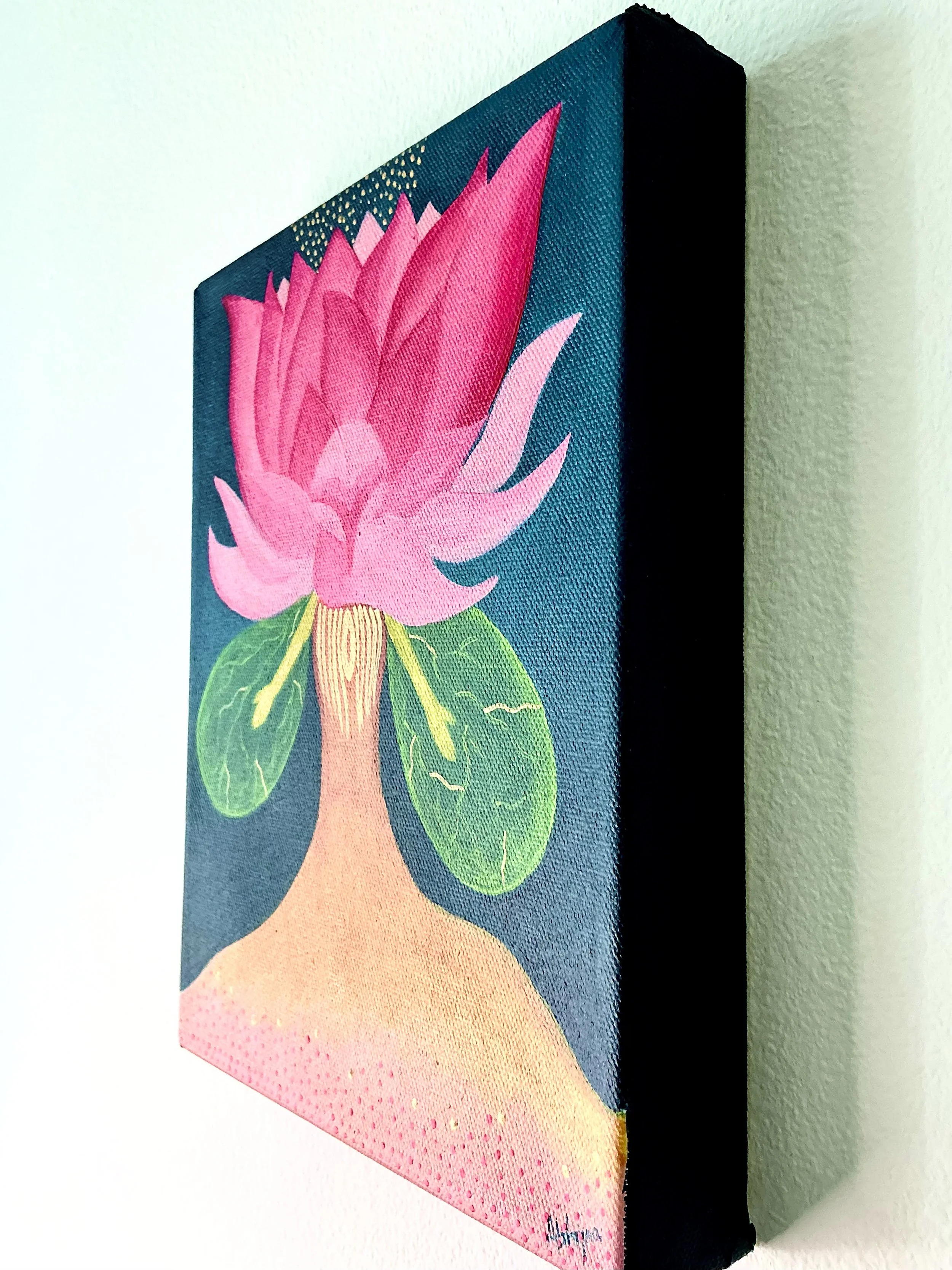 Canvas painting of a pink lotus flower with green leaves and a brown stem against a blue background.