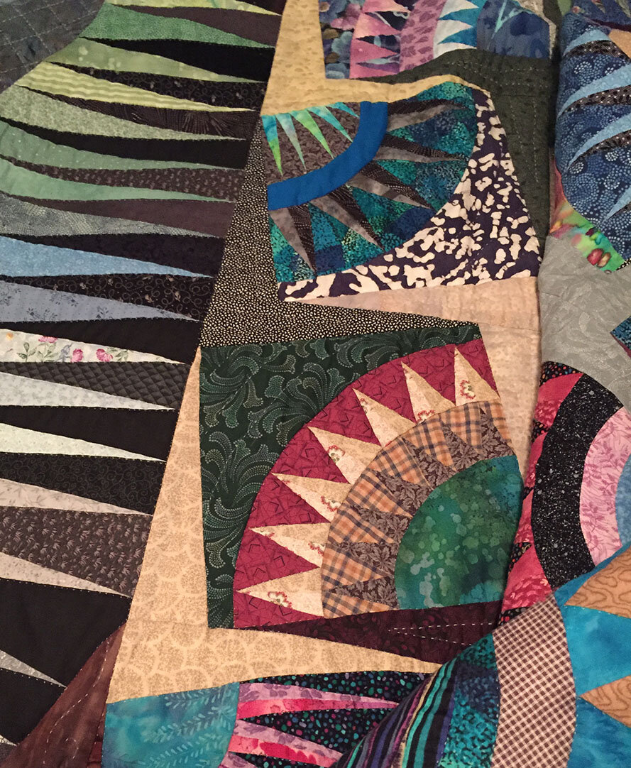 Multi-color American Beauty quilt made by my Mother, Dixie Doyel Youmans.