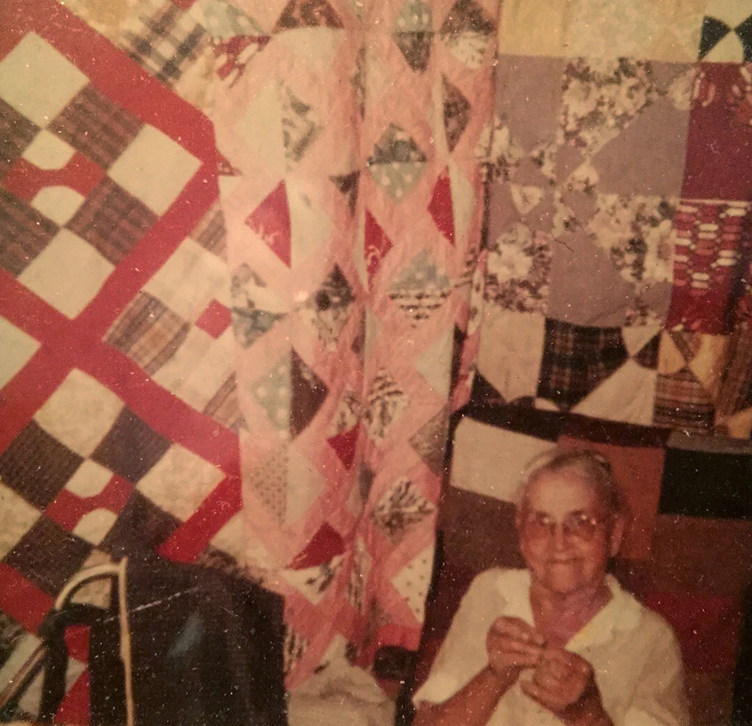 My great grandmother, Dixie Belle Mullins-Johnson, with many of her quilts behind her. She sewed right up to her death.