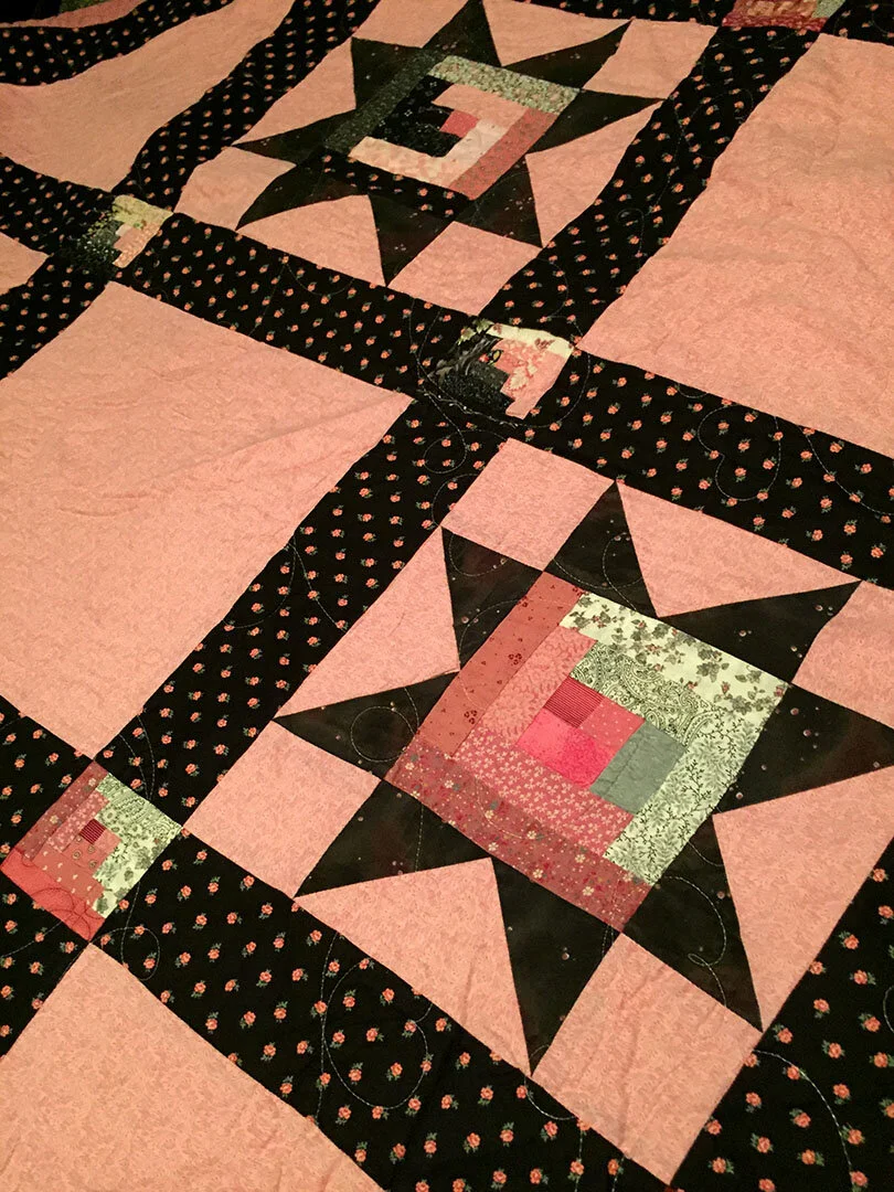 Beautiful pink and black Ohio Star inlaid with Log Cabin pattern quilt made by my Mother, Dixie Doyel Youmans.