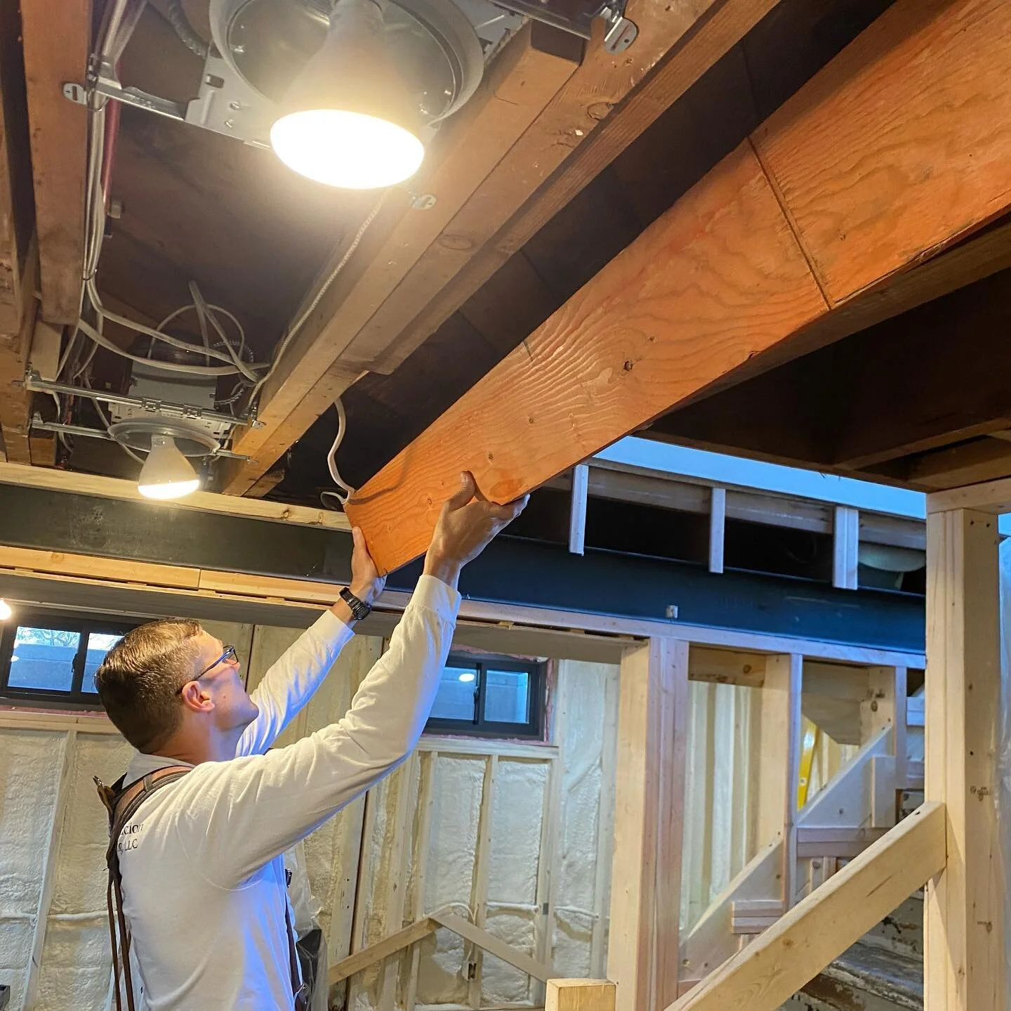 Working through a current remodel we had to add in a new beam to support a stairway above and create more head room for the stairway shown.  We chiseled and planed out a smooth curve to blend it into the existing curved ceiling.  What a difference a