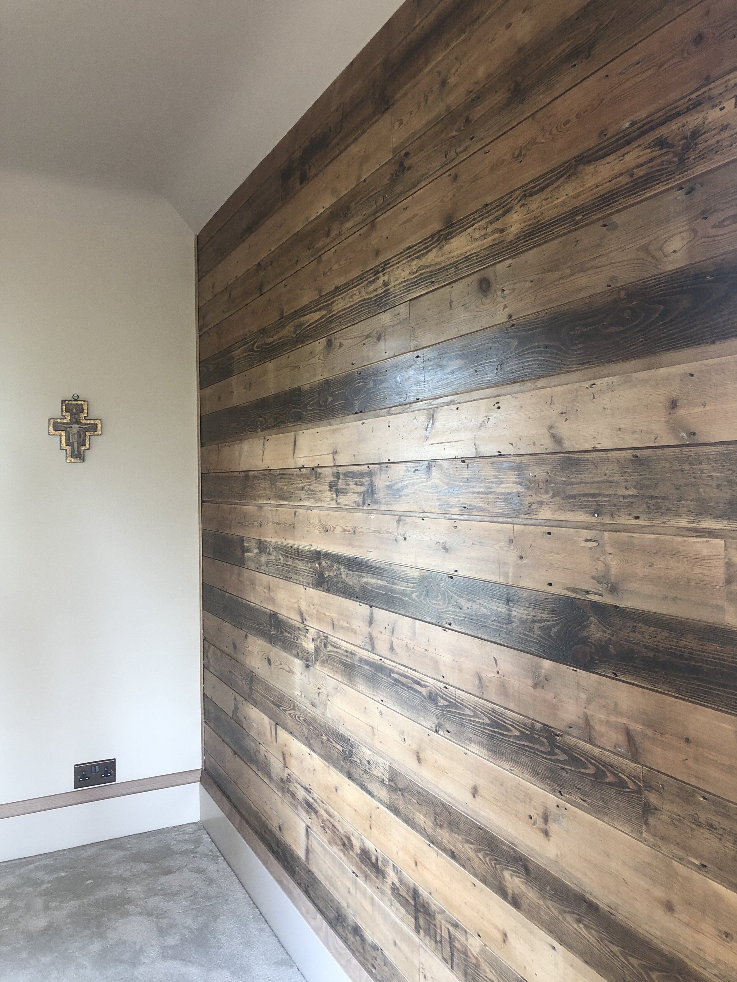 Reclaimed wood wall feature in bedroom.