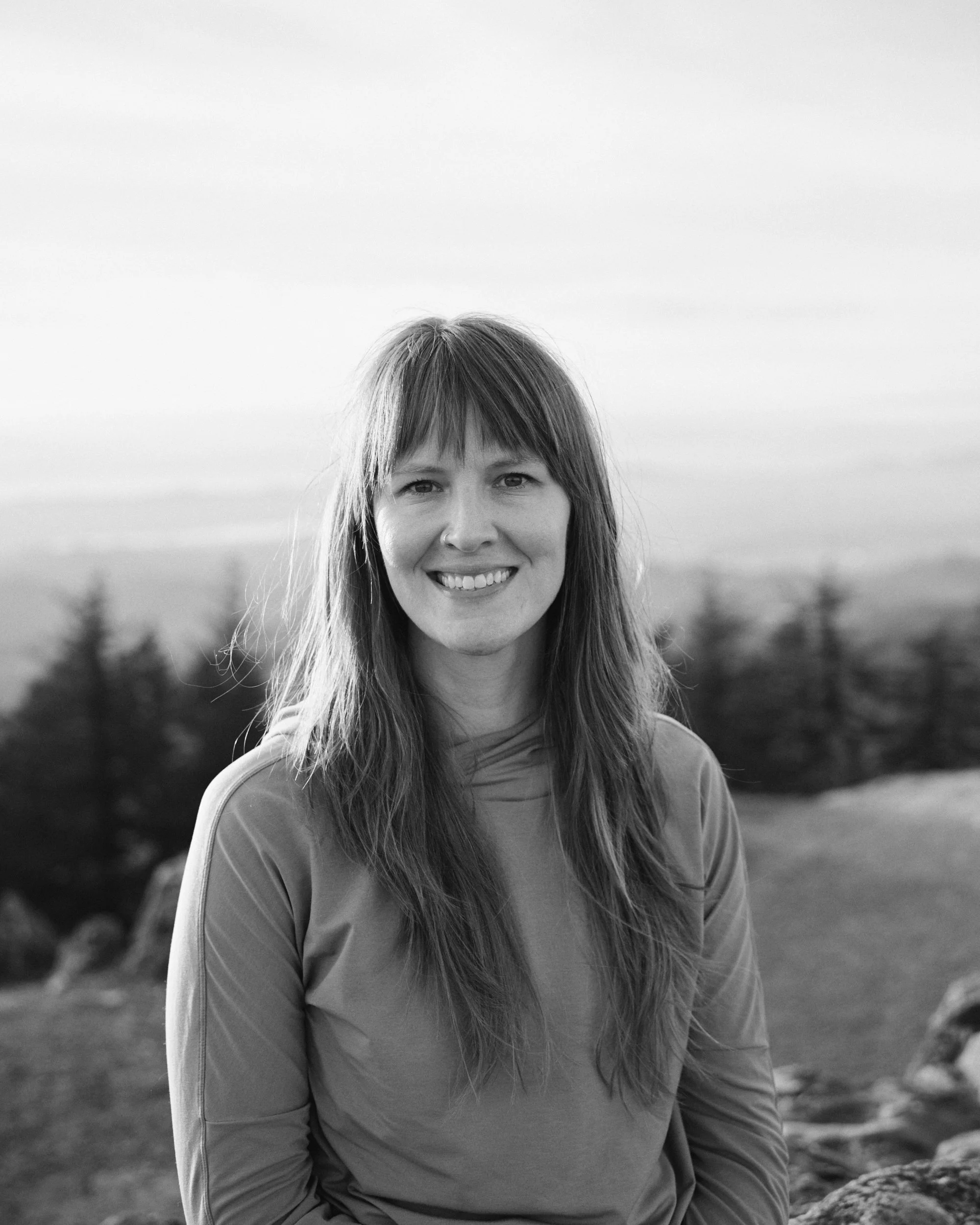 Black and white portrait of a woman on top of Spencer's Butte at Sunset in Eugene Oregon. 