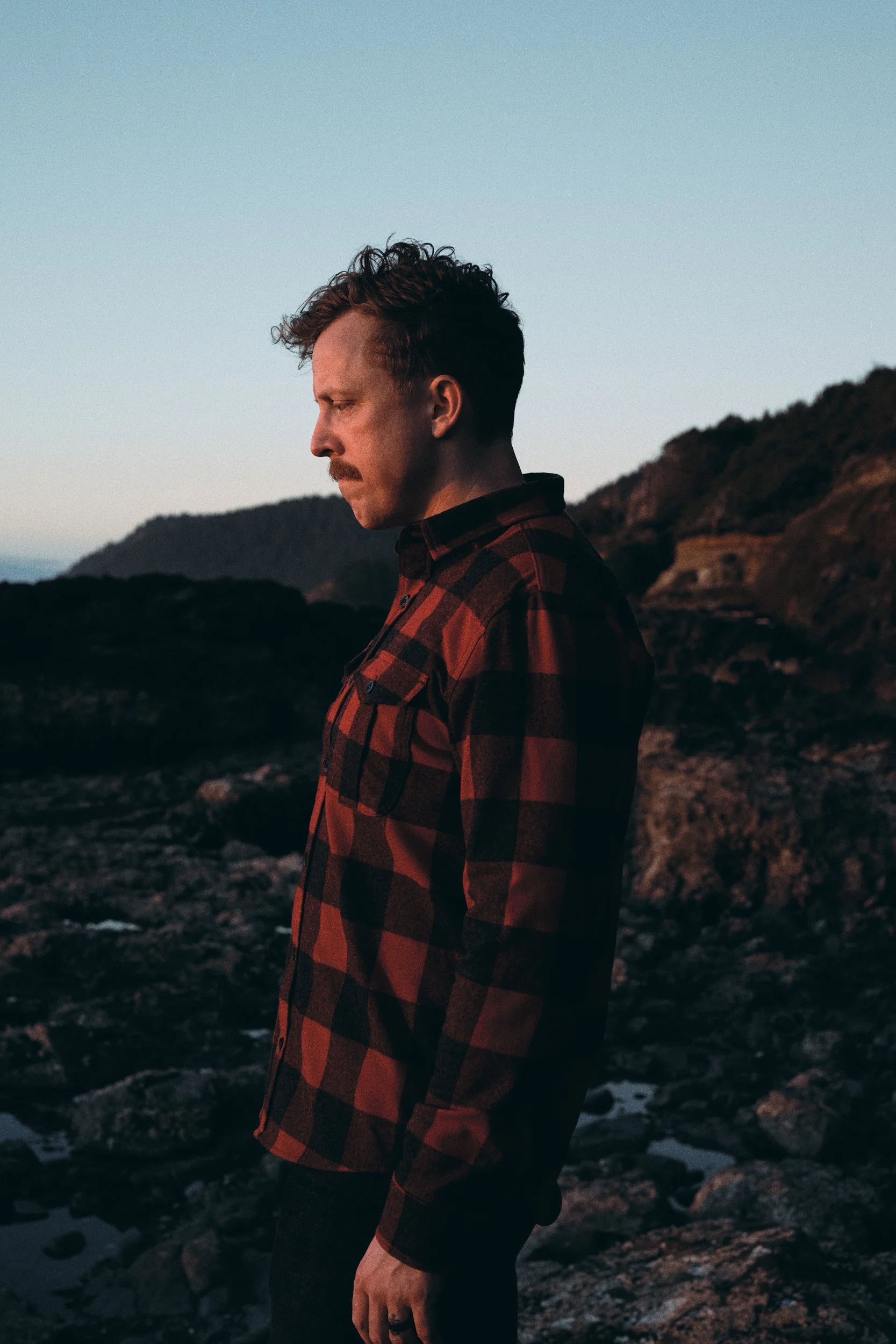 Photographer Blake Robertshaw watches the sunset over the tide pools on the Oregon Coast.