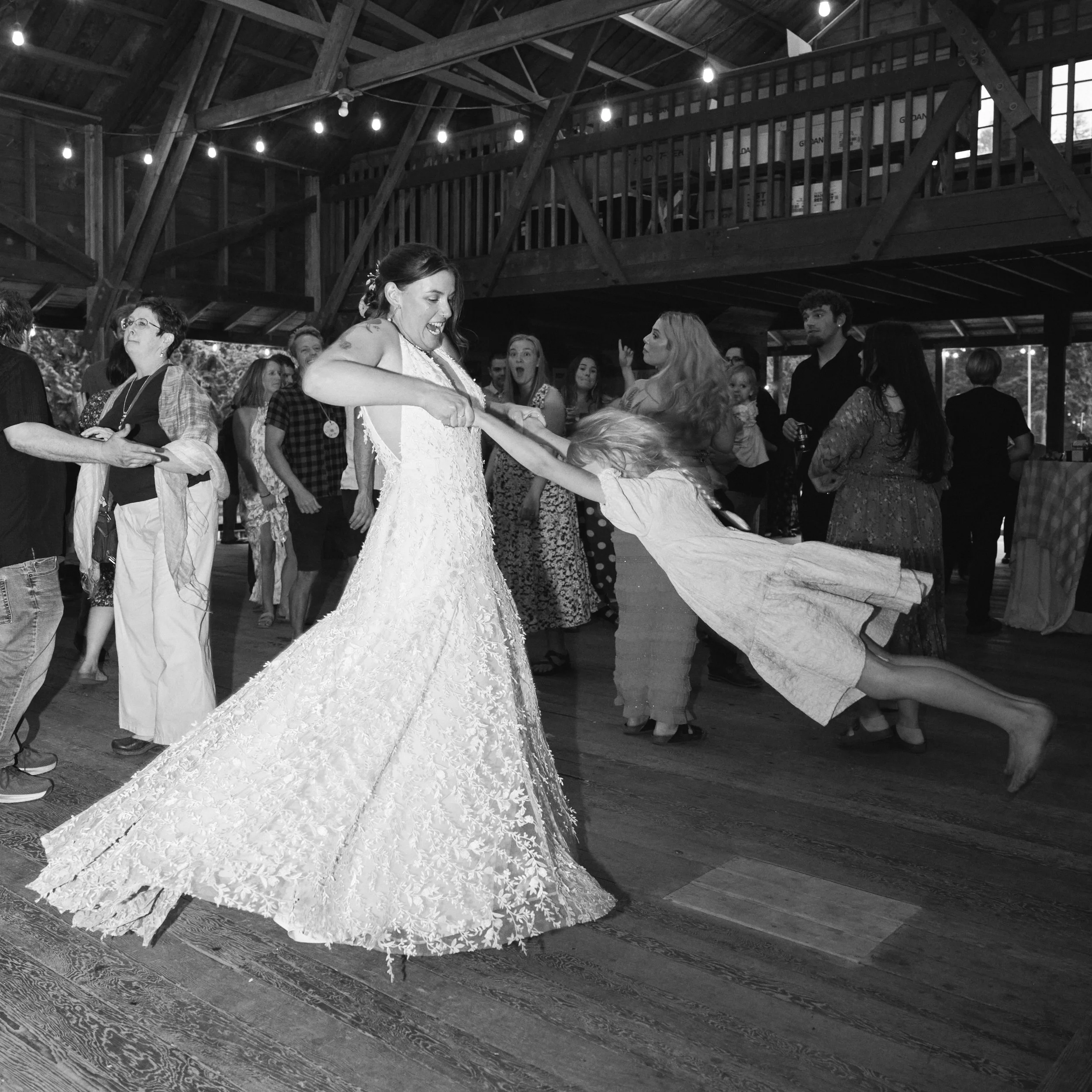 Wedding photography of a bride spinning around a kids on the dance floor in Oregon.
