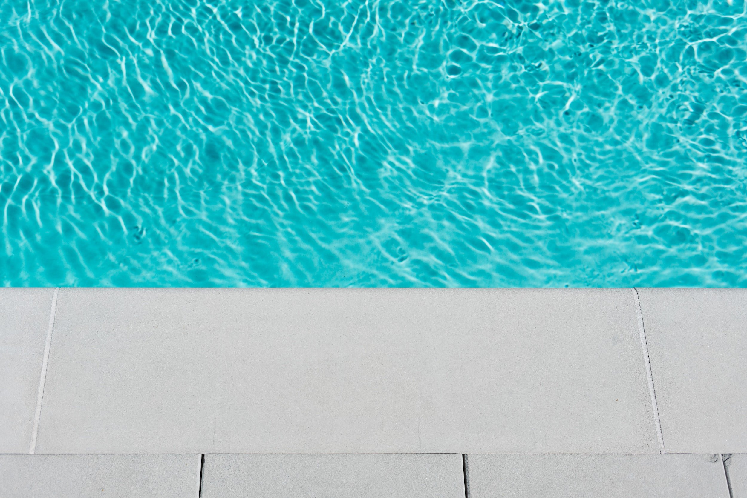 Acid washing eliminates mineral deposits and surface stains from the pool's bottom and sides using an acid solution (usually muriatic acid).