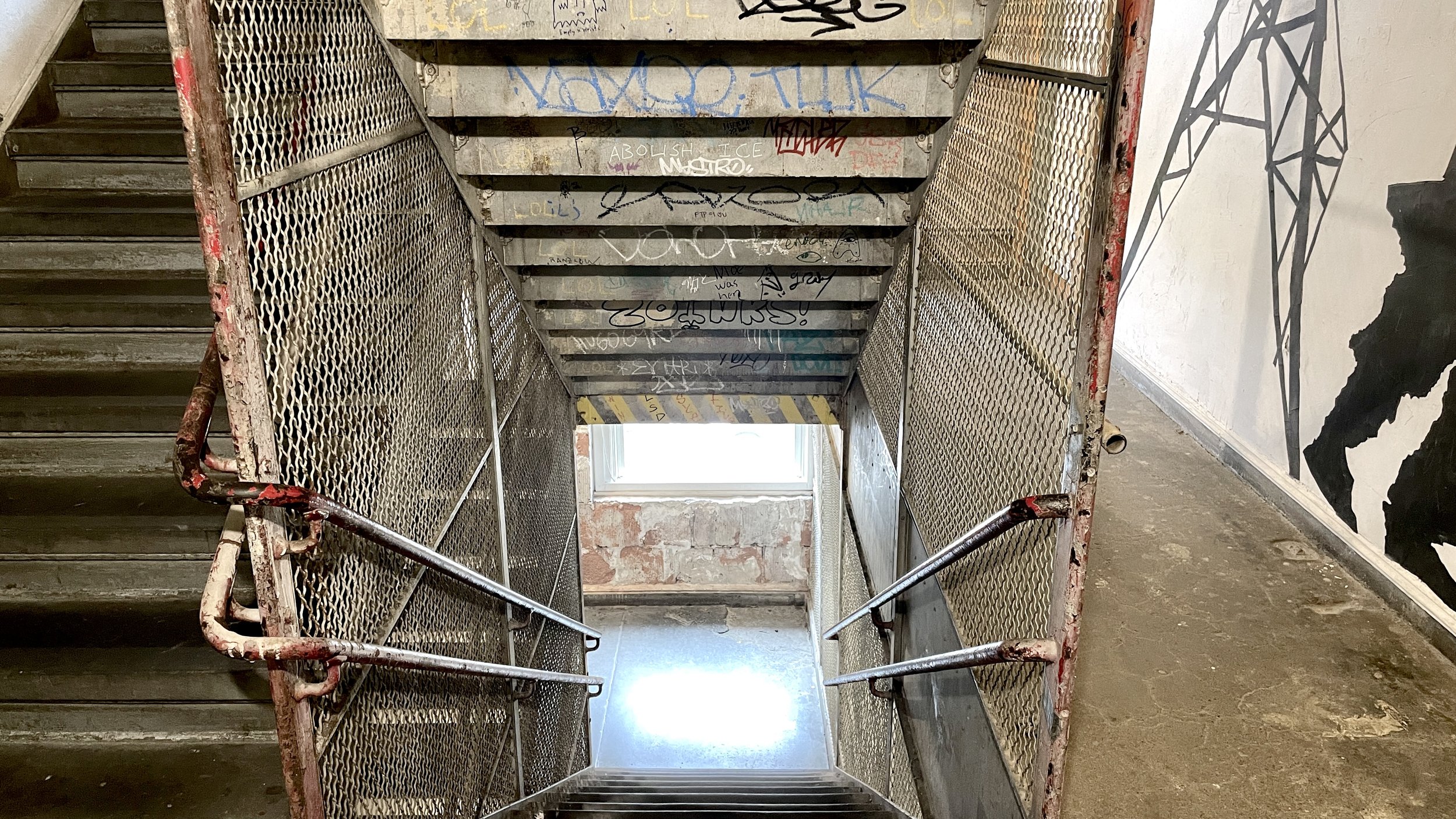 A stairwell littered with graffiti, indicative of the underground spirit of New York. (Copy)