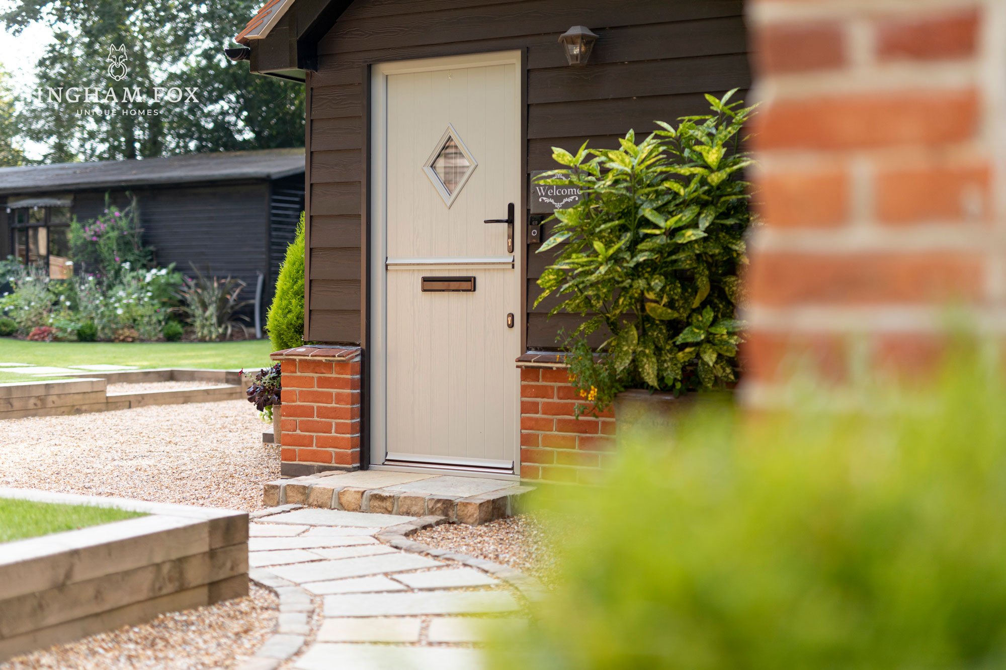 Front door of a small house with a path and garden