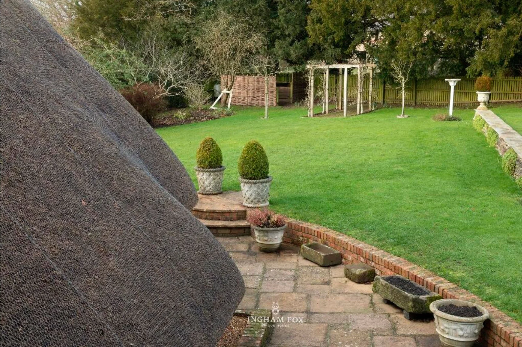 looking-round-the-thatched-roof-to-the-garden.jpg