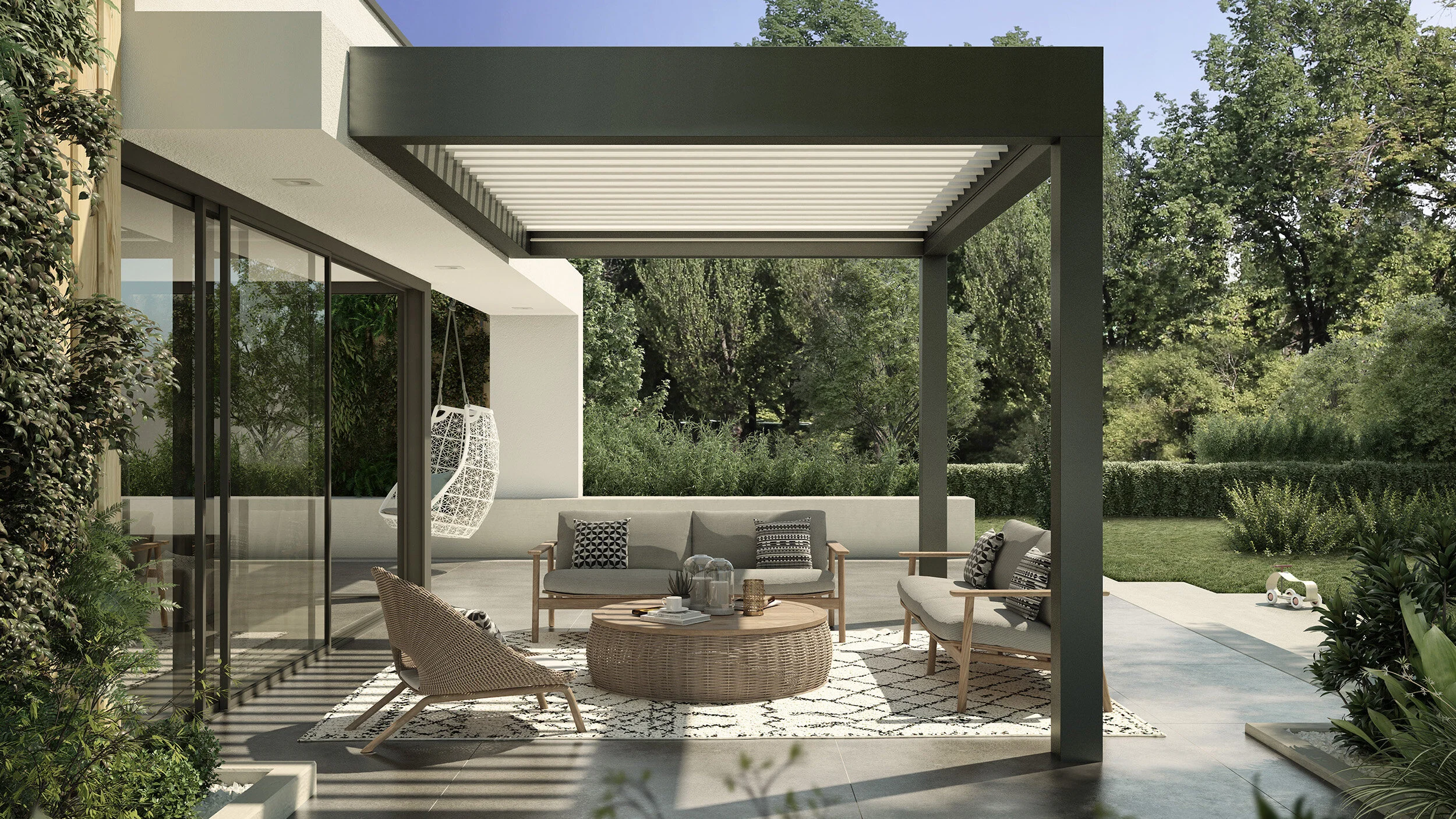 Modern outdoor patio with pergola, cozy seating, wicker table, cushioned chairs, patterned rug, and garden view.