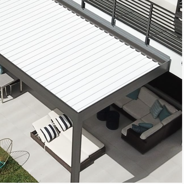 Modern outdoor patio with a white pergola, striped cushions on chairs, and patio furniture.