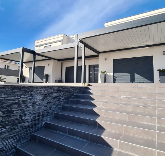 Modern house exterior with stone steps and metal awning