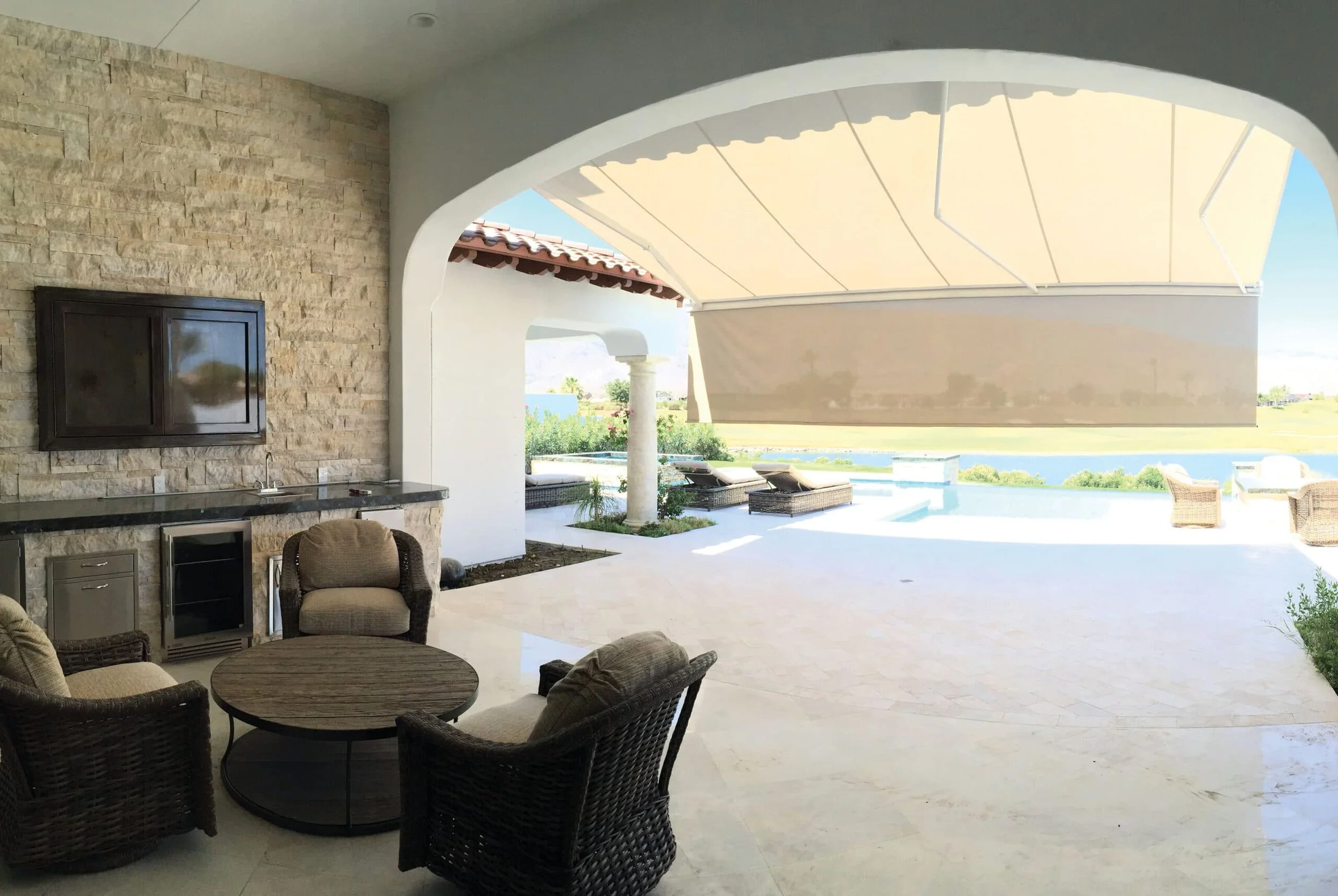 Outdoor patio with retractable awning shade near pool in San Diego County installed by San Diego Patio Pros