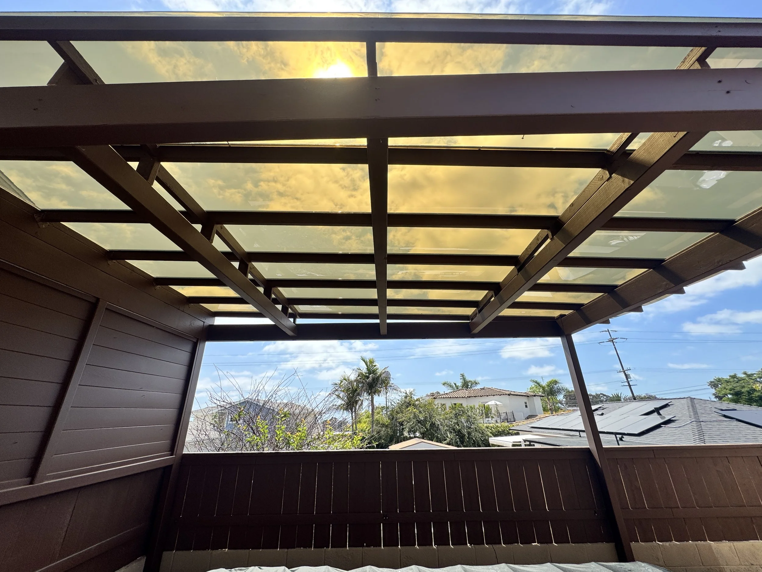 Polycarbonate roof panel installation in San Diego, view from beneath bronze EZ Glaze panels showing light transmission