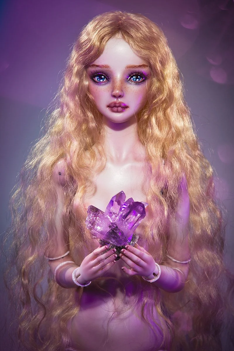 Elixia porcelain doll holding crystal