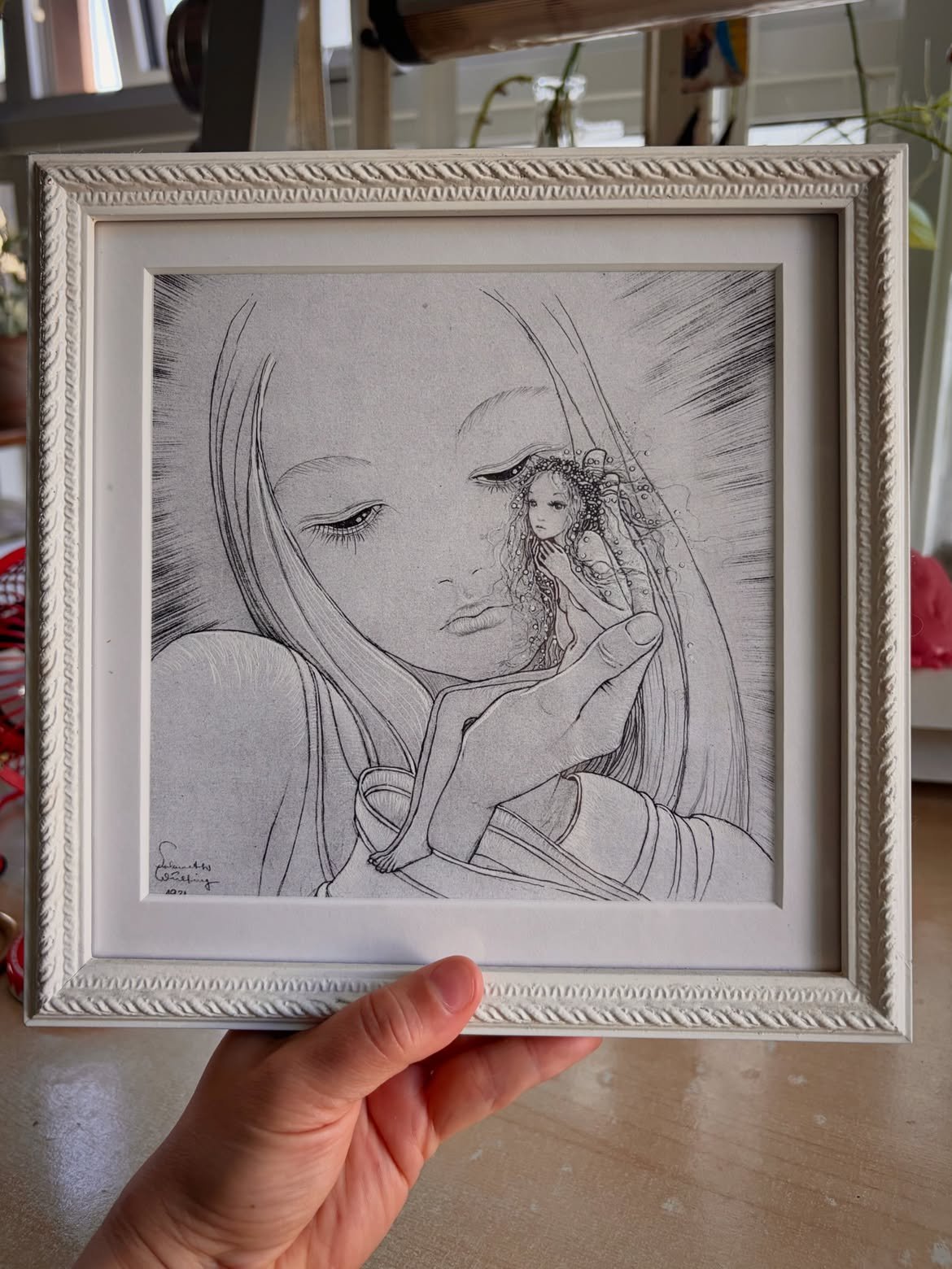 holding a frame print of sulamith Wulfing