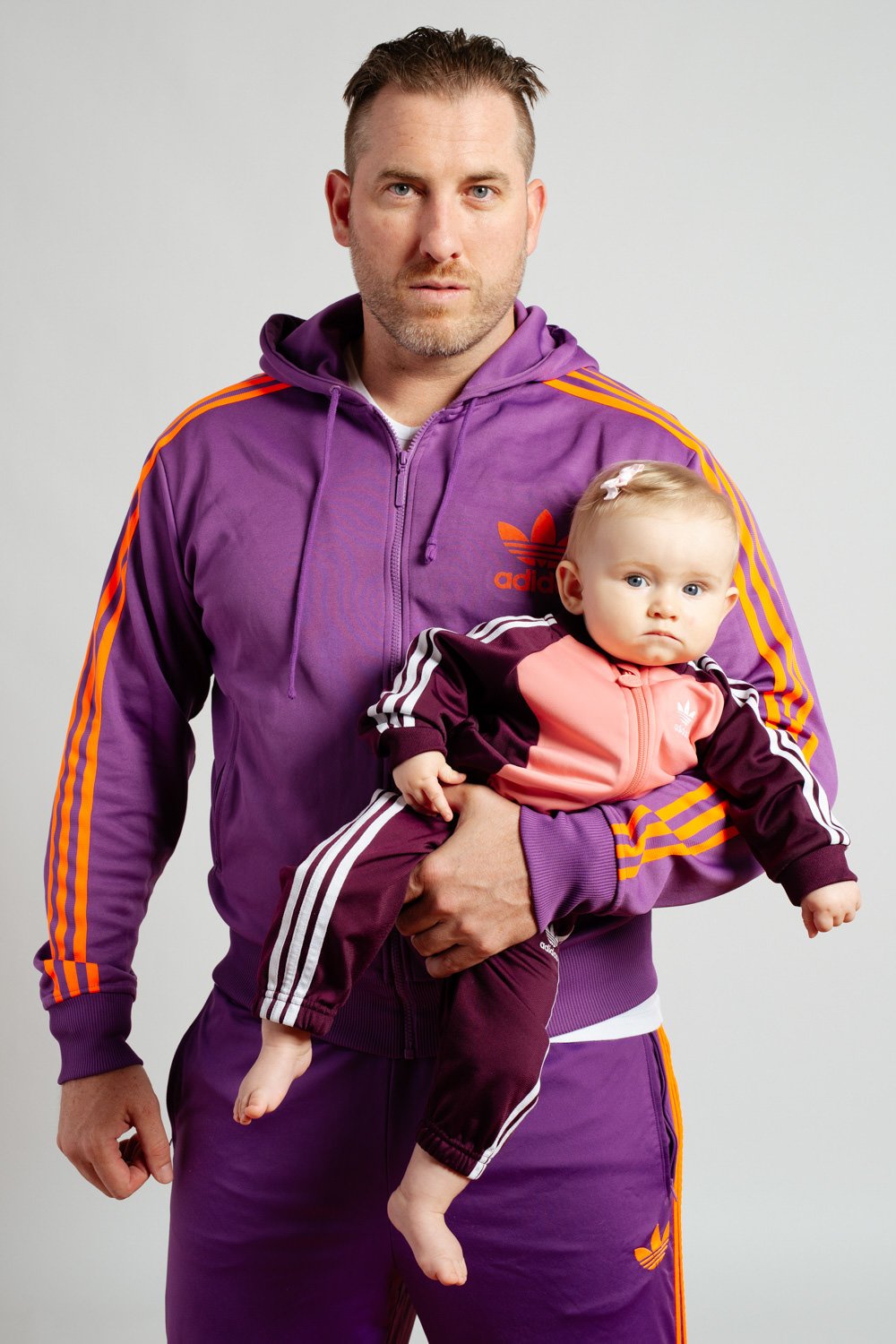 father-baby-matching-adidas-jumpsuits-studio-portrait.jpg