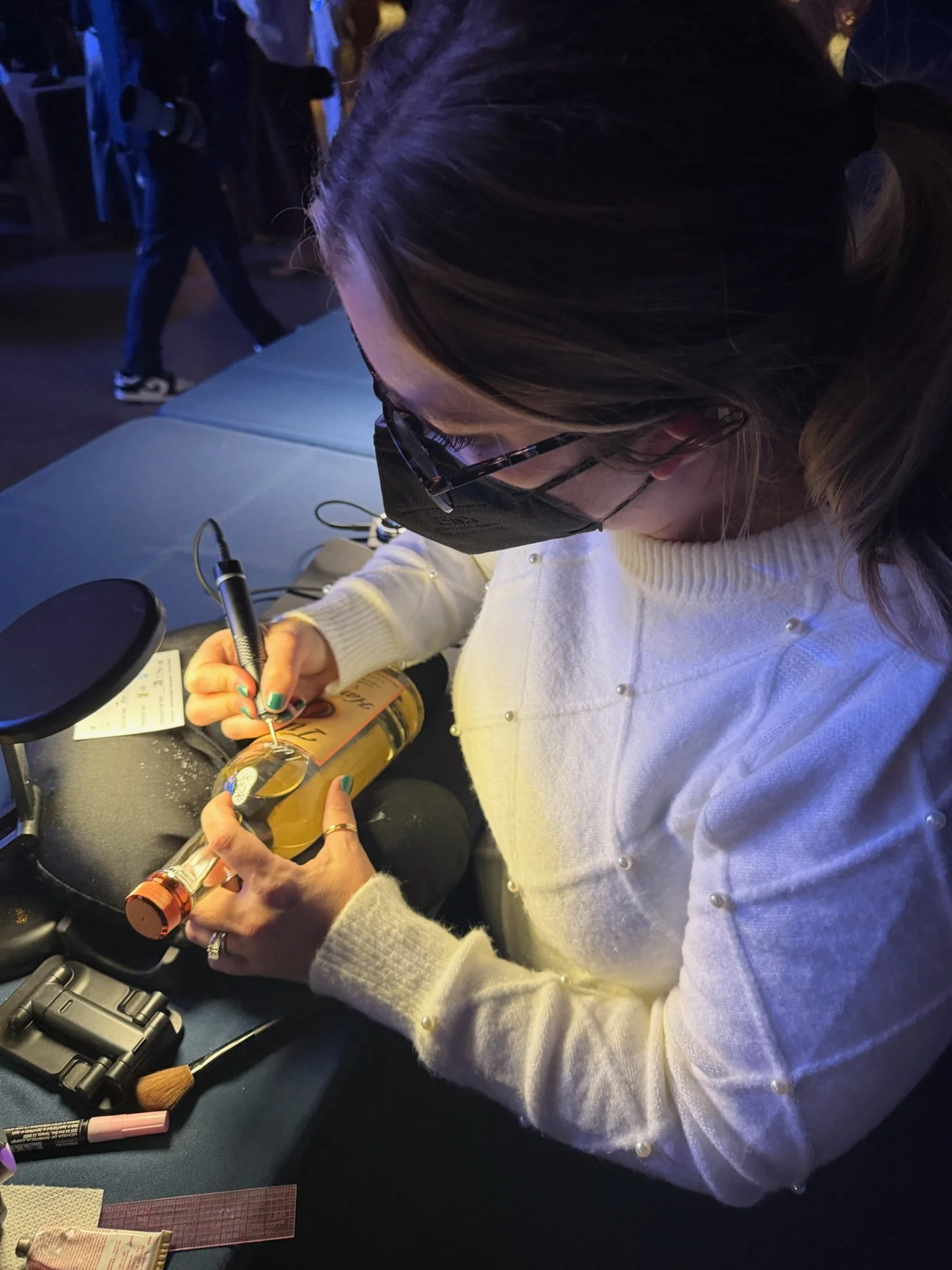 engraving a bottle of Tito's for guests at holiday party