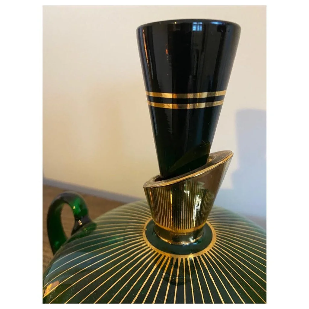 Dry January might just have to wait! 

Look at this simply magnificent, elegant and decadent original Art Deco hand-blown emerald-green and gold glass decanter with matching glasses. 

Would look beautiful positioned on a shelf or a window sill - all
