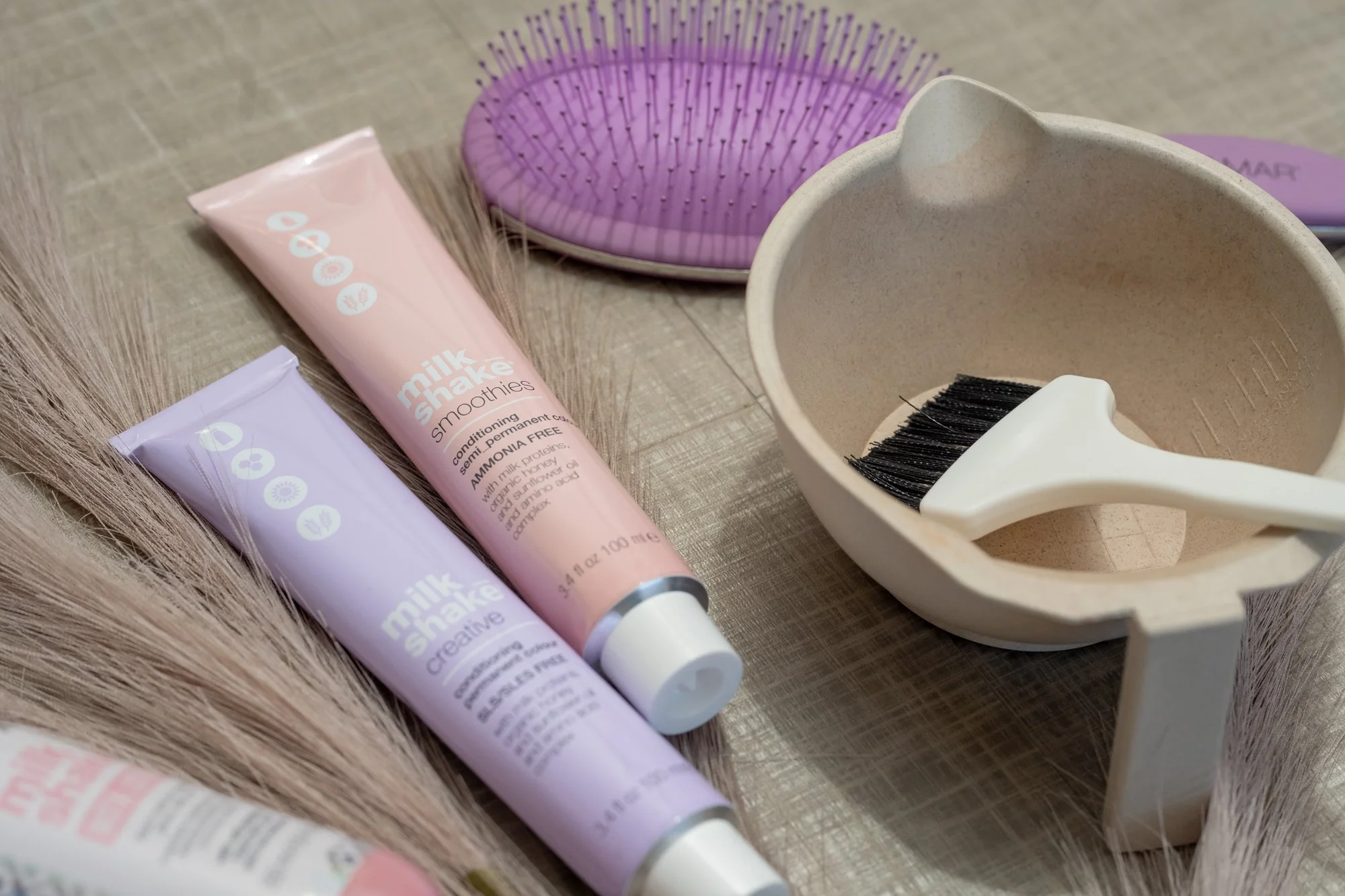 Hair care tools including tubes of Milk Shake hair styling products, Hair color services and products used at Moxxi Grey Salon in Colleyville, TX Leading Hair stylists and expert Hairdressers offering top-rated Hair styling services in DFW