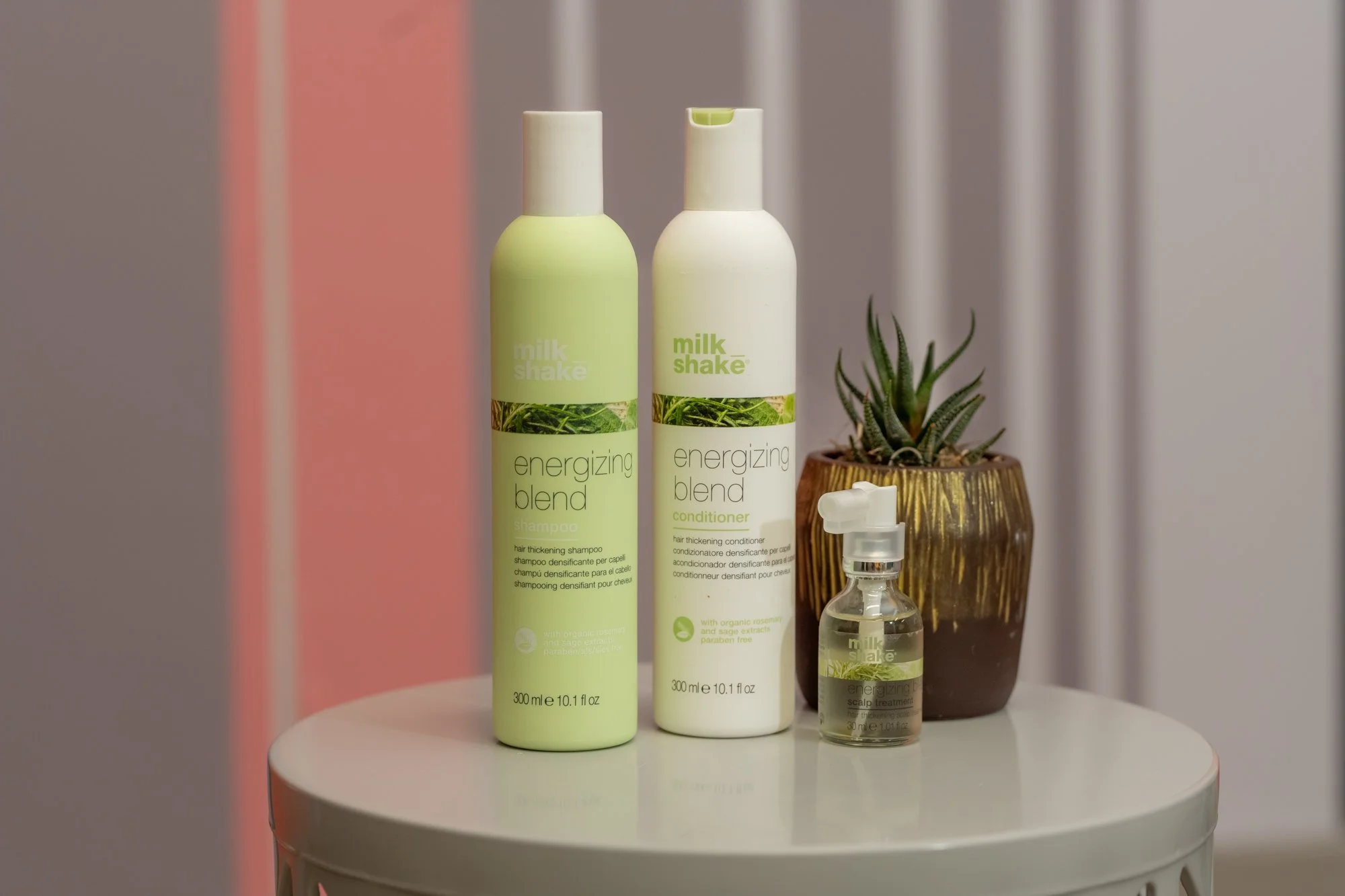 Three bottles of Milk Shake hair care products sold at Moxxi Grey Salon in Colleyville, TX