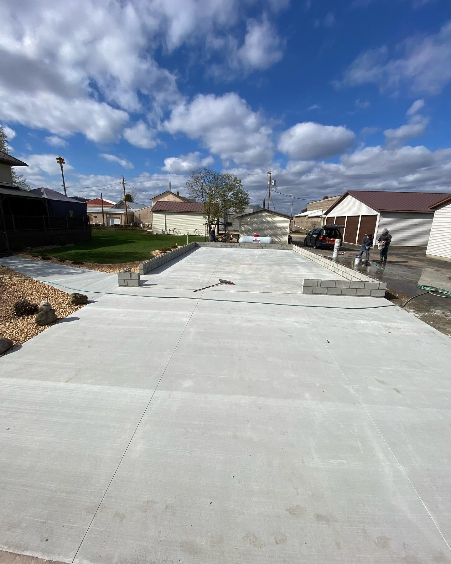 Had this garage picked up and moved offsite so we could tear out the old garage floor and driveway, raise it up a foot, repour it, lay block, and they will now set the garage back on it.