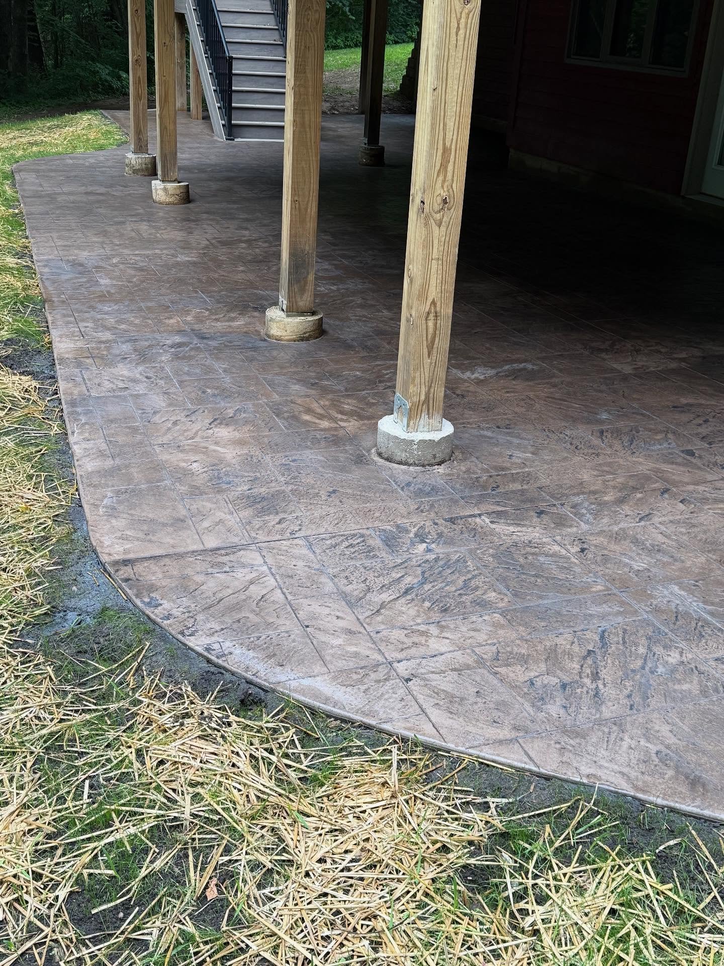 Large stamped  patio under the deck. Perfect shady spot. Interstate chocolate fudge 1 bag with dark gray release.