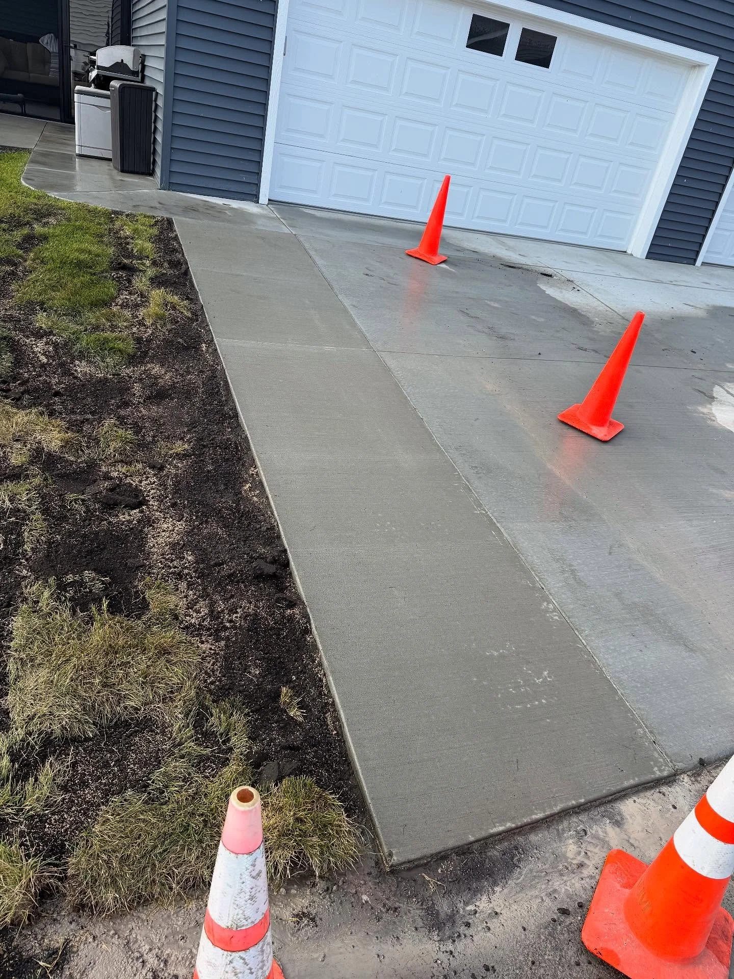 Homeowners were tired of stepping into the snow bank so we widened the driveway and put in a little patio extension