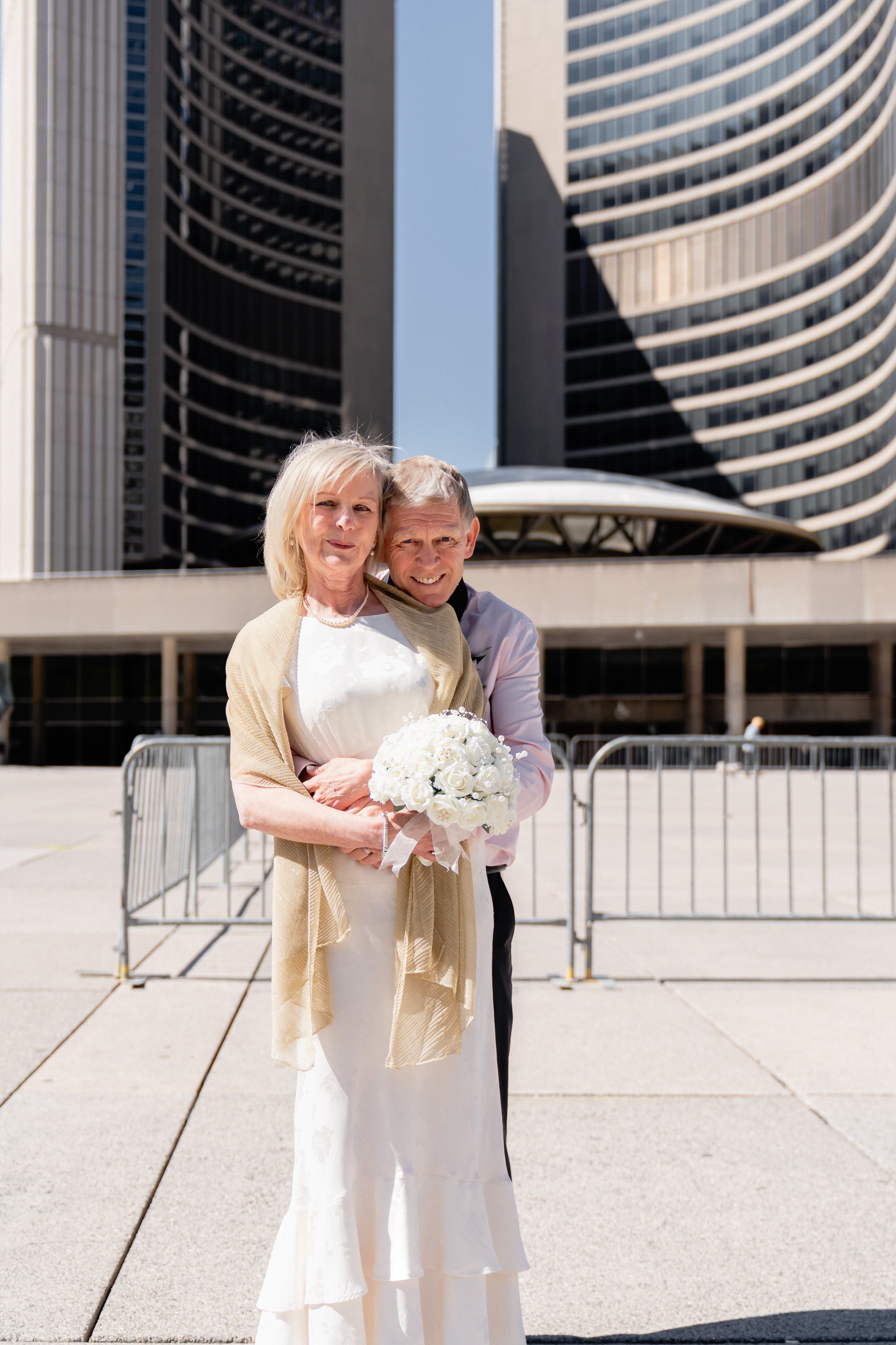Wedding portraits near iconic arches at Nathan Phillips Square