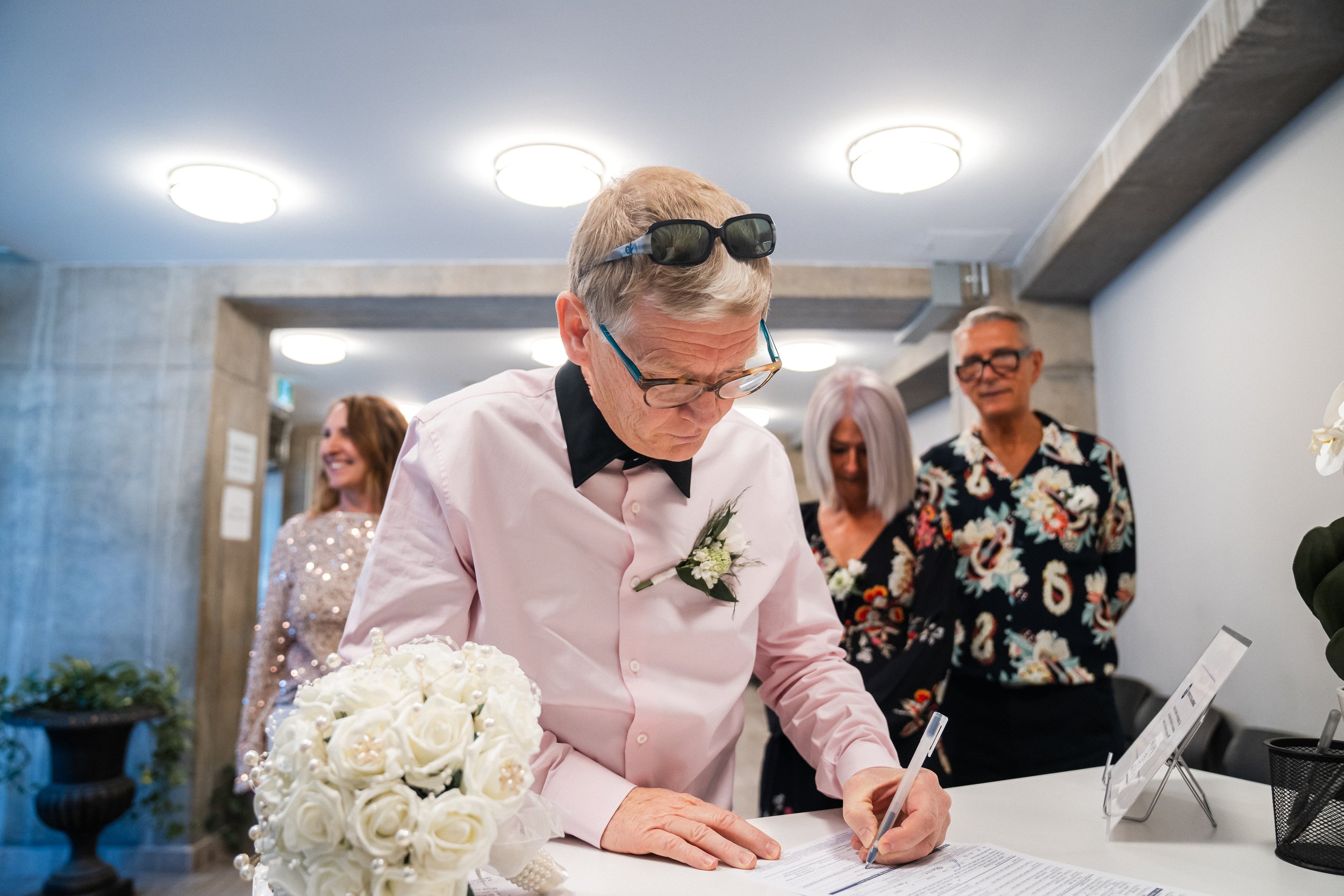Signing the marriage registry during a City Hall civil wedding