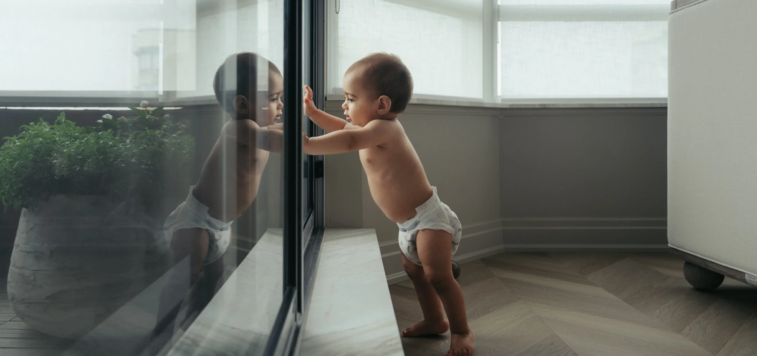 toronto-family-photographer-baby-playing-kitchen-floor.jpg