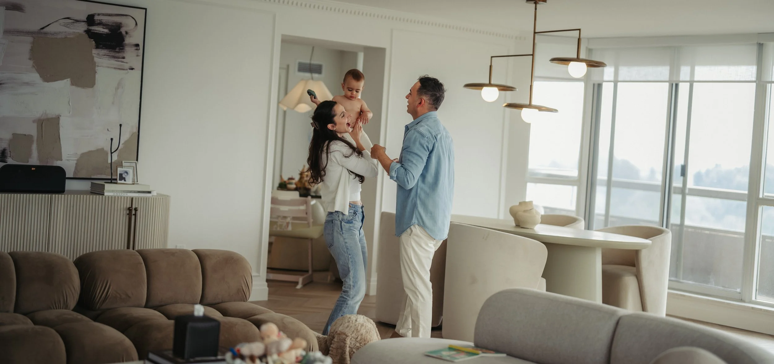 in-home-family-photography-toronto-parents-dancing-with-baby.jpg