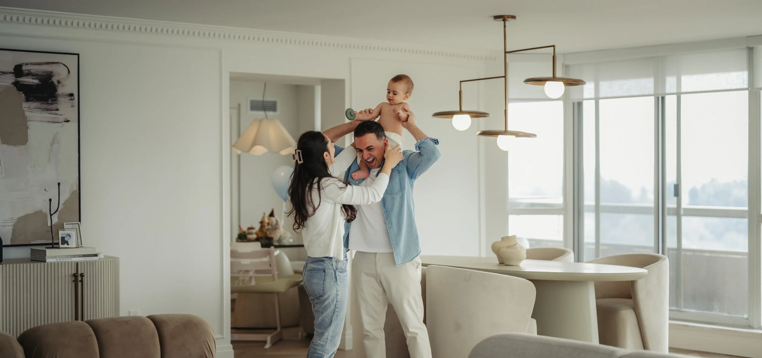 toronto-condo-family-session-living-room-dad-lifting-baby.jpg