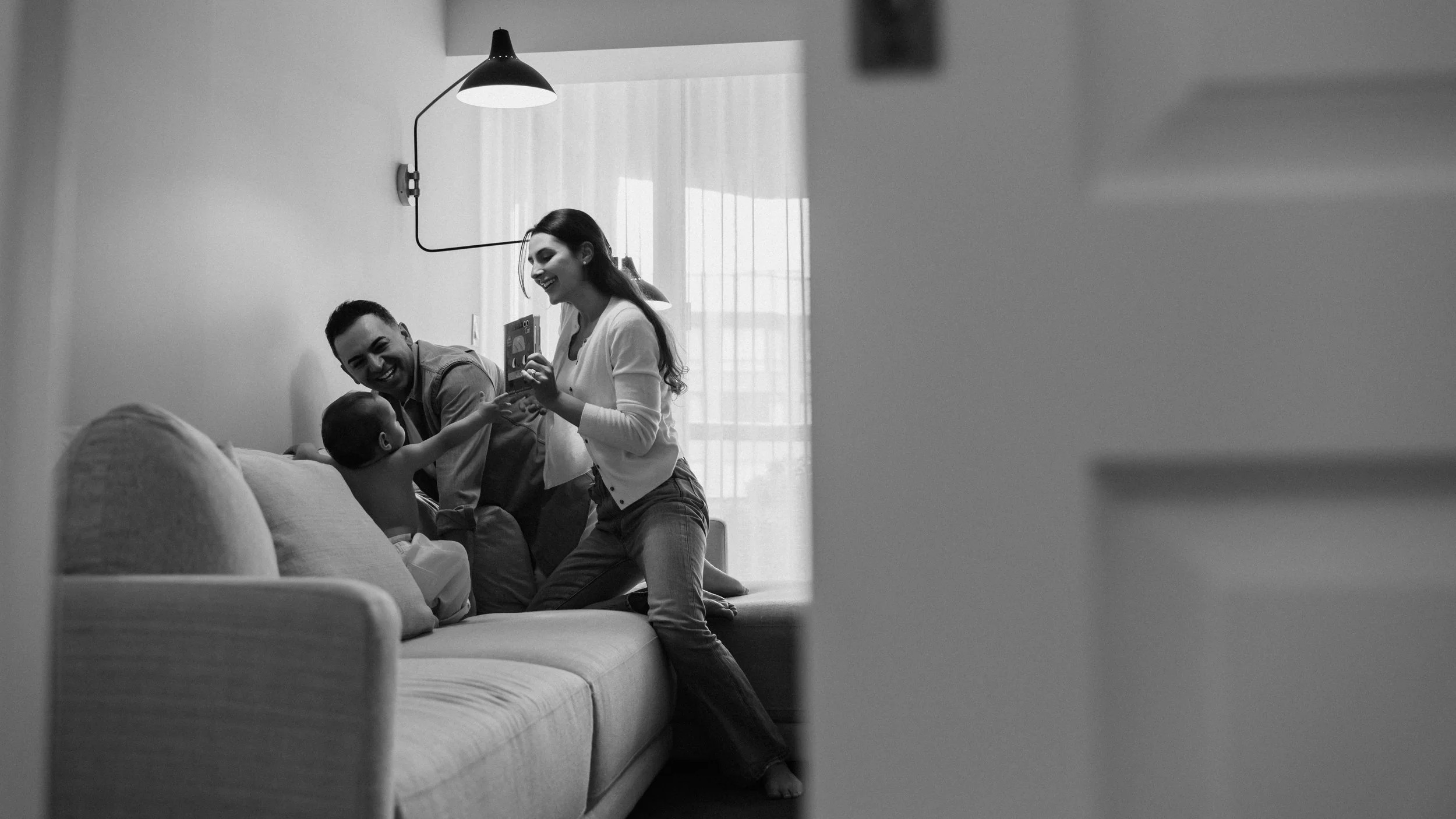 black-and-white-family-photography-toronto-parents-playing-couch.jpg