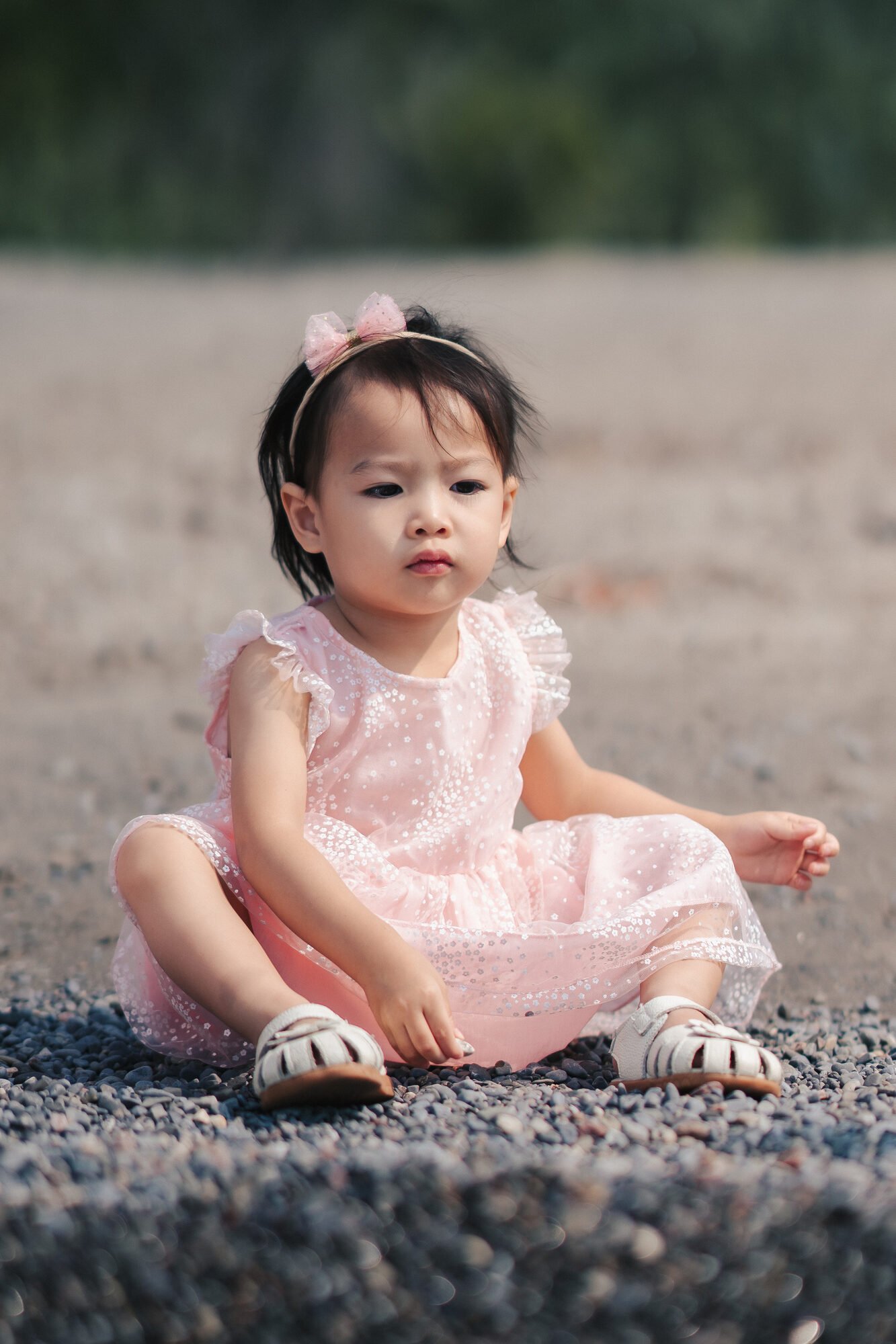 scarborough-bluffs-family-photos-child-sitting-on-pebble-beach.jpg
