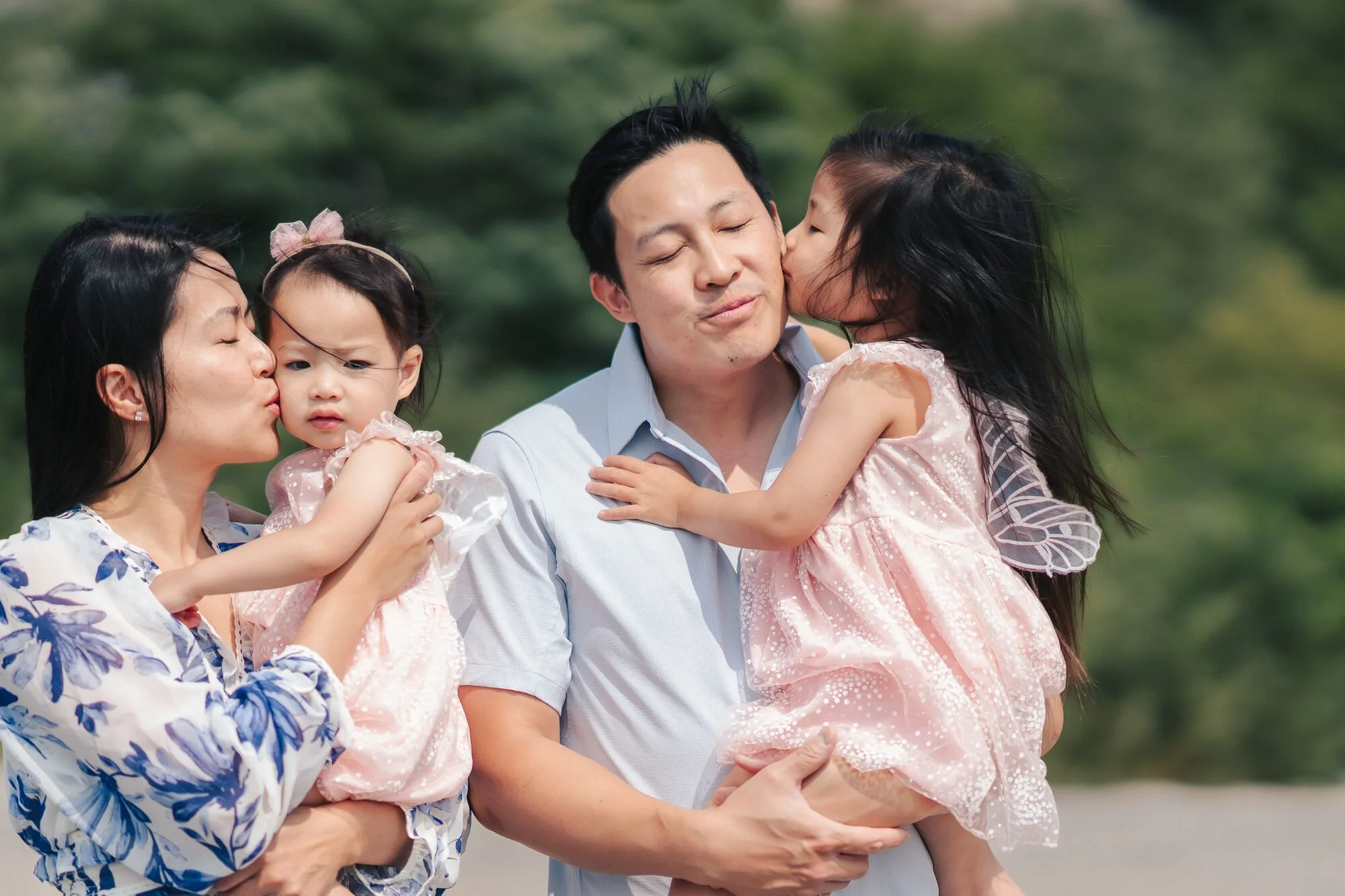documentary-family-photography-toronto-parents-kissing-daughters.jpg
