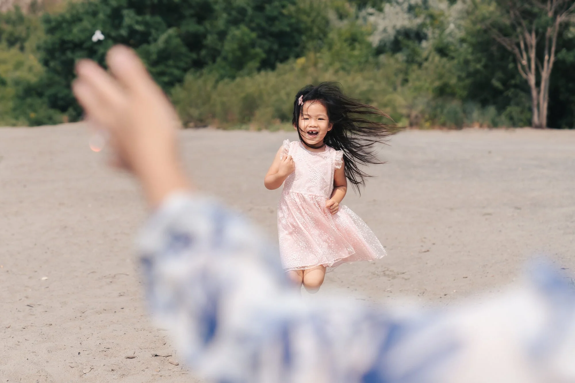 documentary-family-photography-toronto-child-running-on-beach.jpg