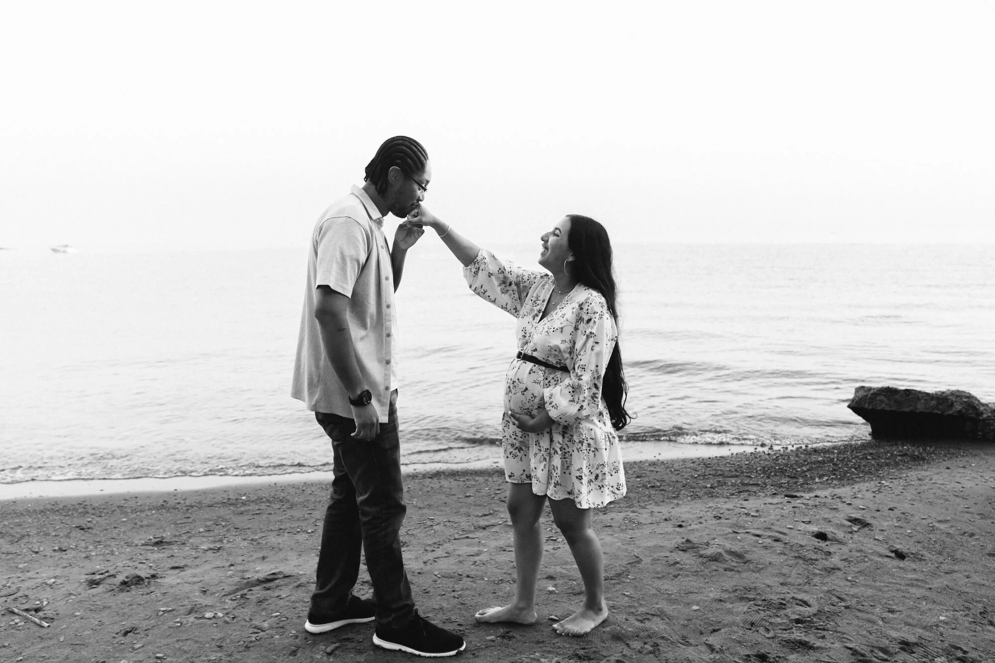 scarborough-bluffs-maternity-session-kissing-her-hand-at-sunset.jpg