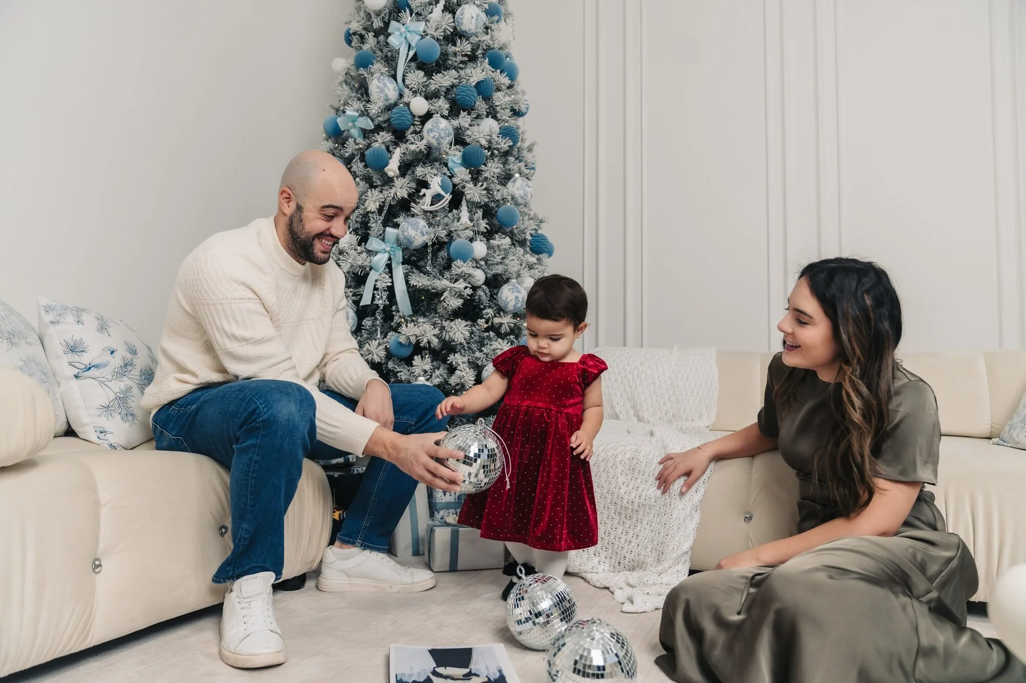 family-with-toddler-on-sofa-christmas-mini-session-toronto-icon-studio-space.jpg