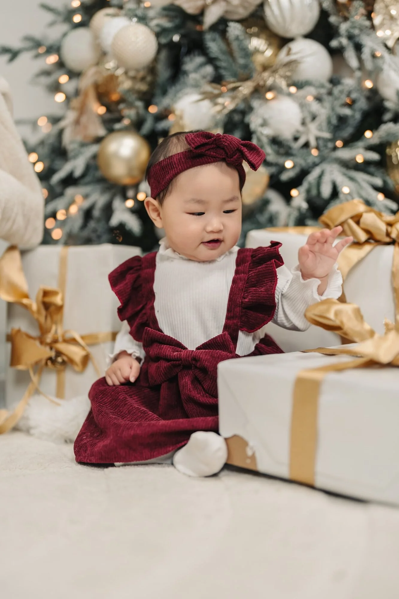 baby-girl-in-burgundy-christmas-mini-session-icon-studio-space-toronto.jpg