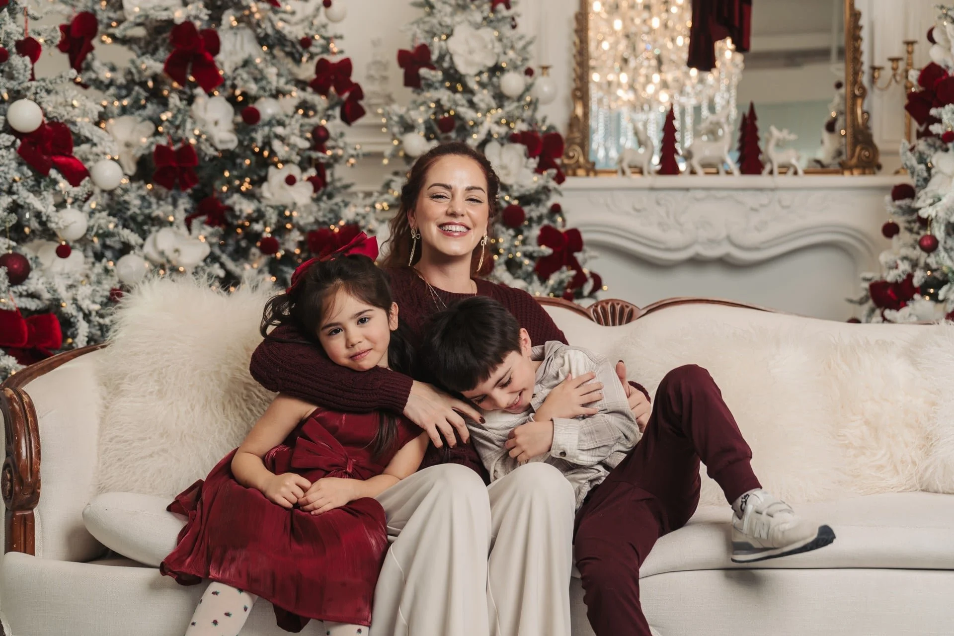 	Mother and children cuddling at a burgundy Christmas photoshoot, Toronto
