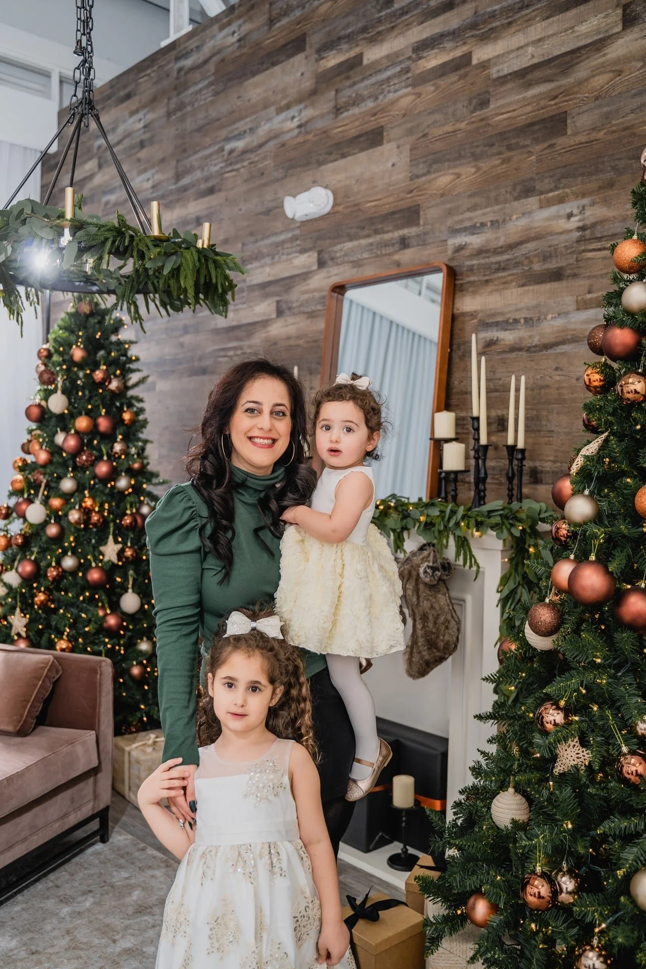 	Mother and two children beside a decorated Christmas tree, Toronto photoshoot
