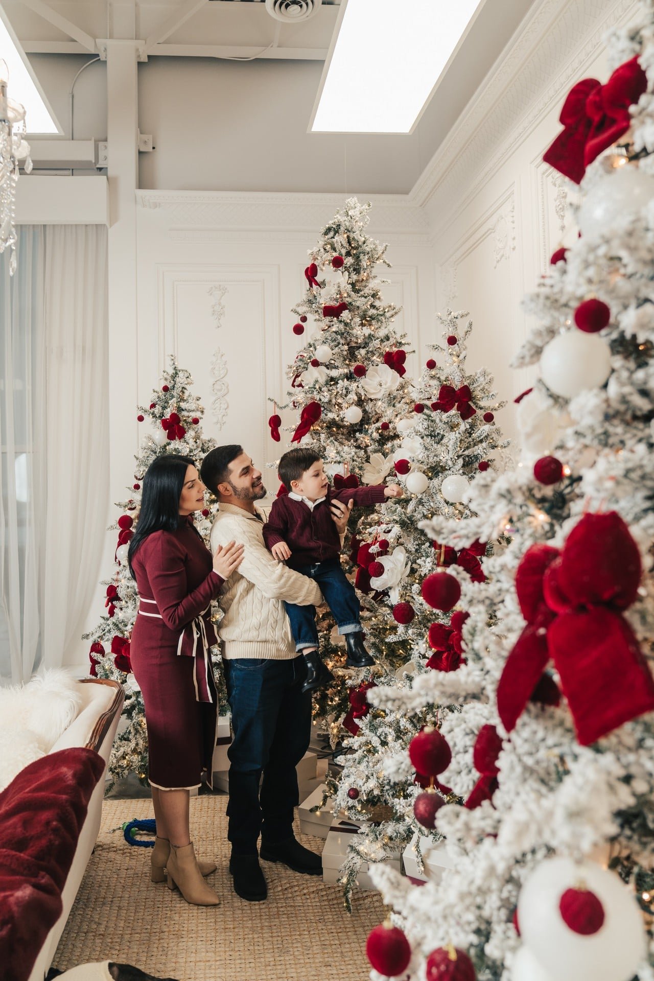 	Mother and baby by a red-decorated Christmas tree, Toronto photoshoot