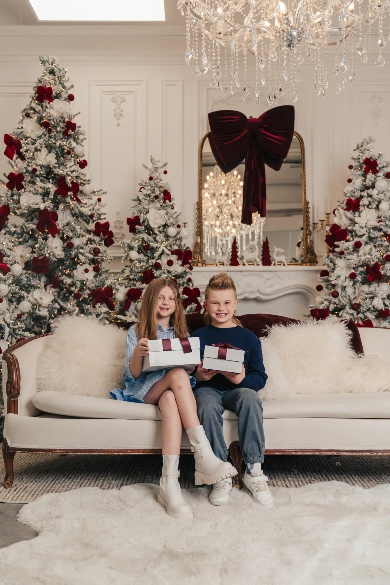 	Two siblings holding gifts at a Christmas photoshoot, Toronto studio