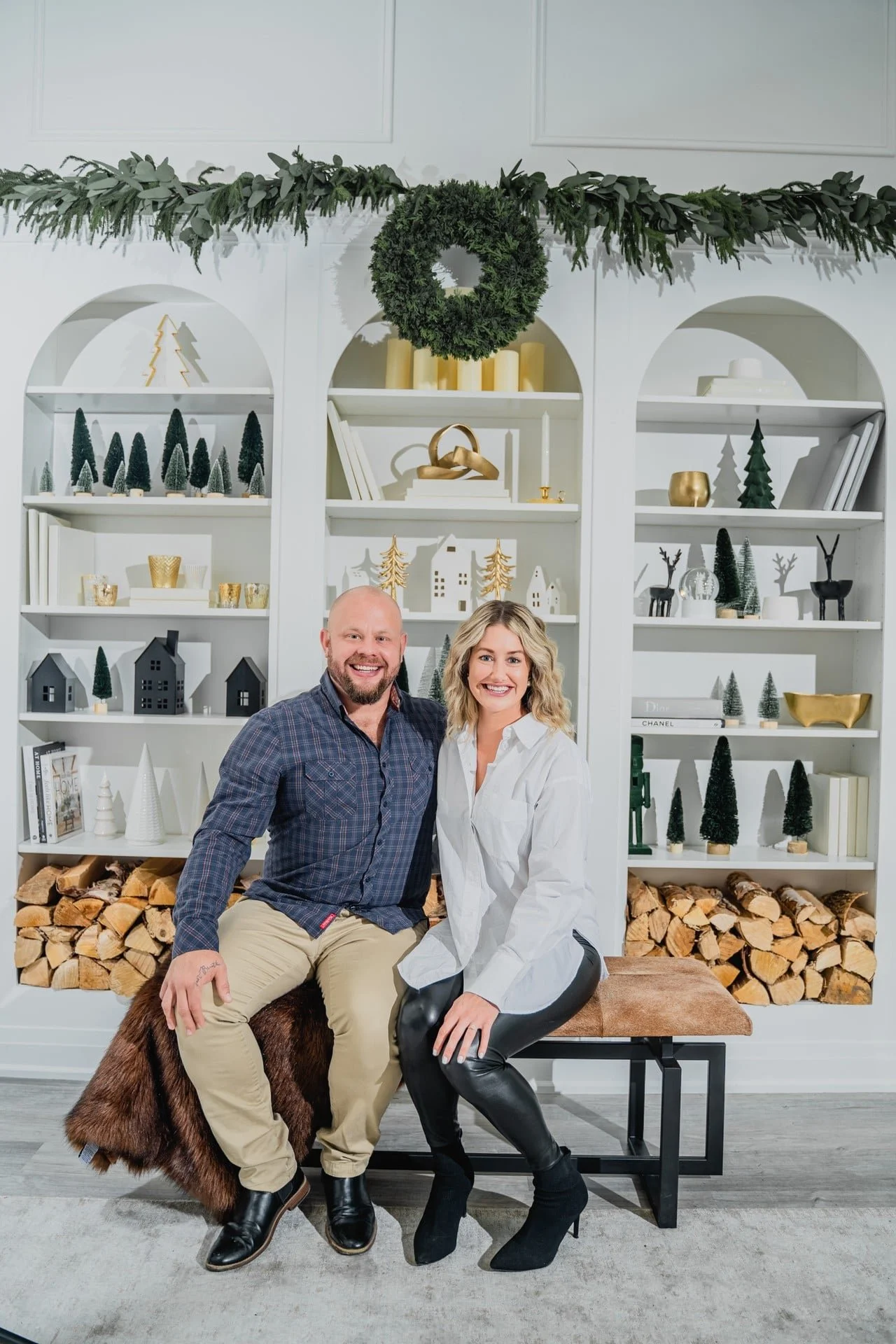 Couple's Christmas photoshoot in a Toronto studio with a decorated bookshelf set