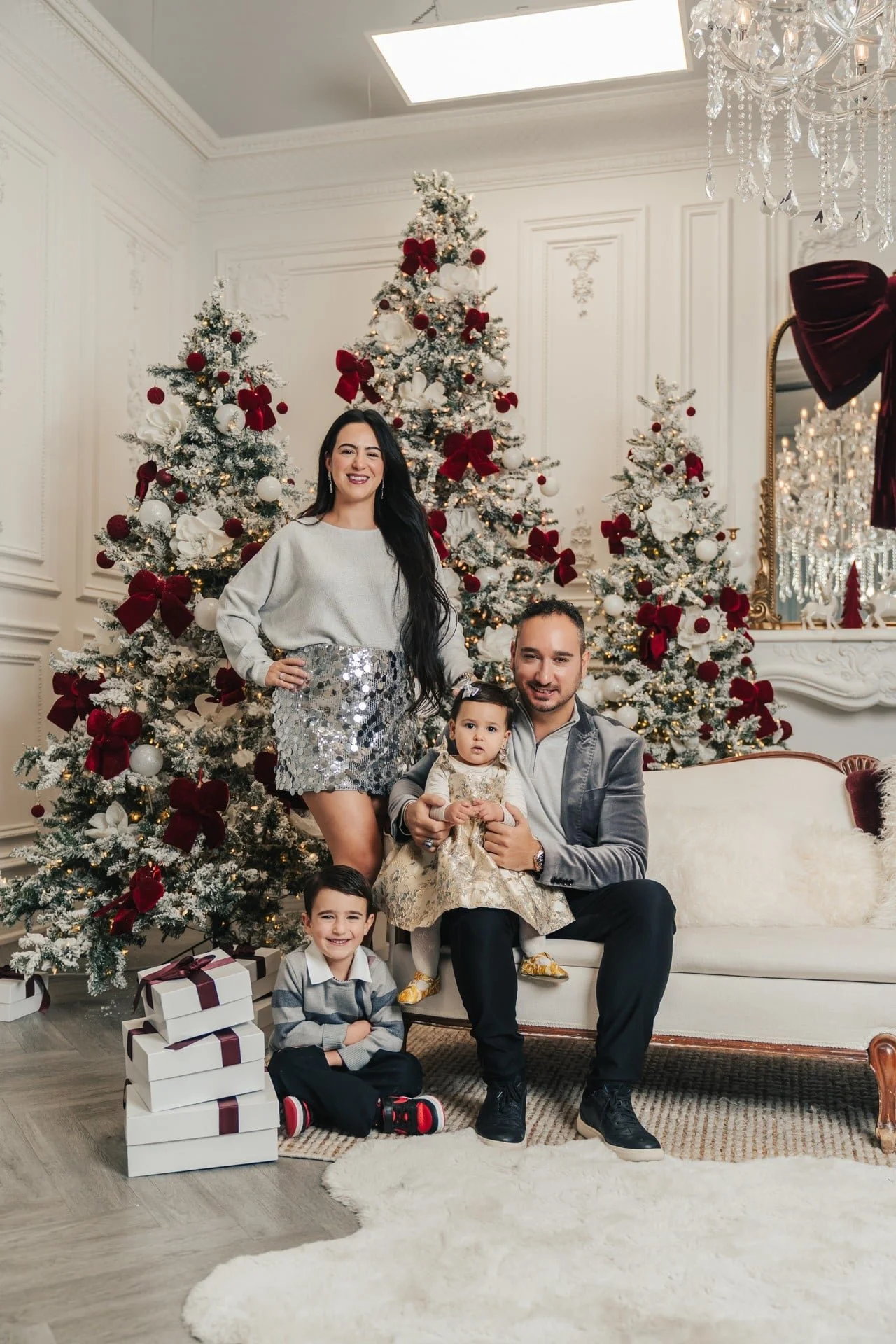 Family Christmas photoshoot in an elegant burgundy and white studio, Toronto