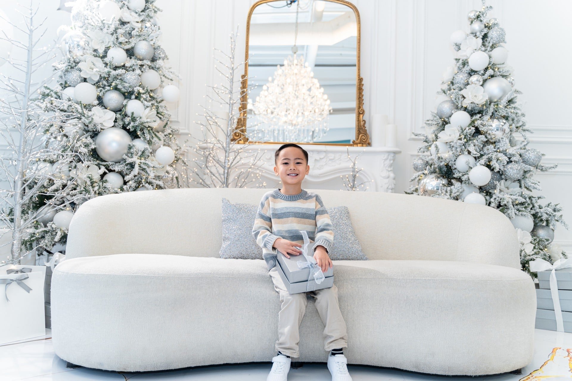Young boy at a Christmas mini photoshoot in a white winter studio, Toronto