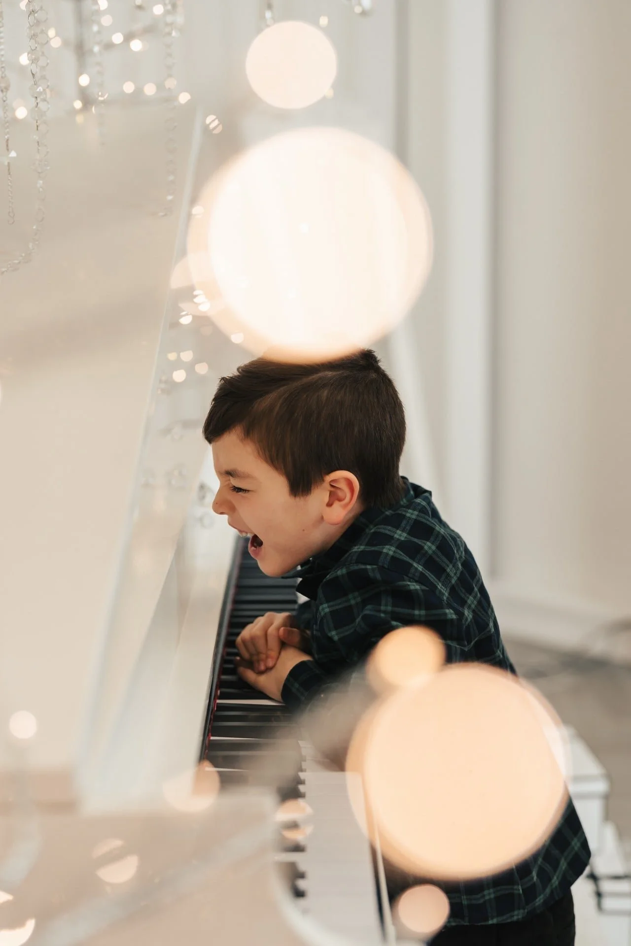 	Boy at a piano during a candid Christmas photoshoot, Toronto studio