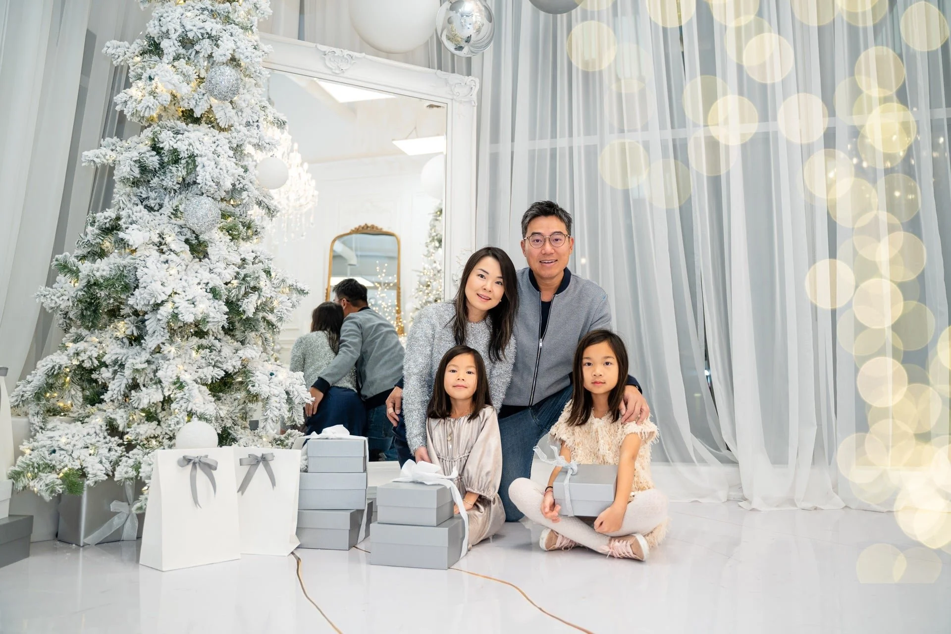Family Christmas photoshoot with white drapes and fairy lights, Toronto